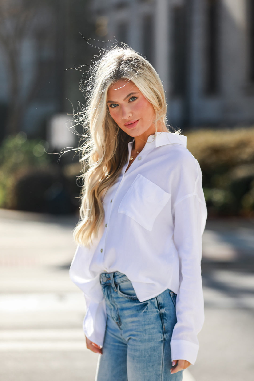 model wearing a cute basic white button-up blouse