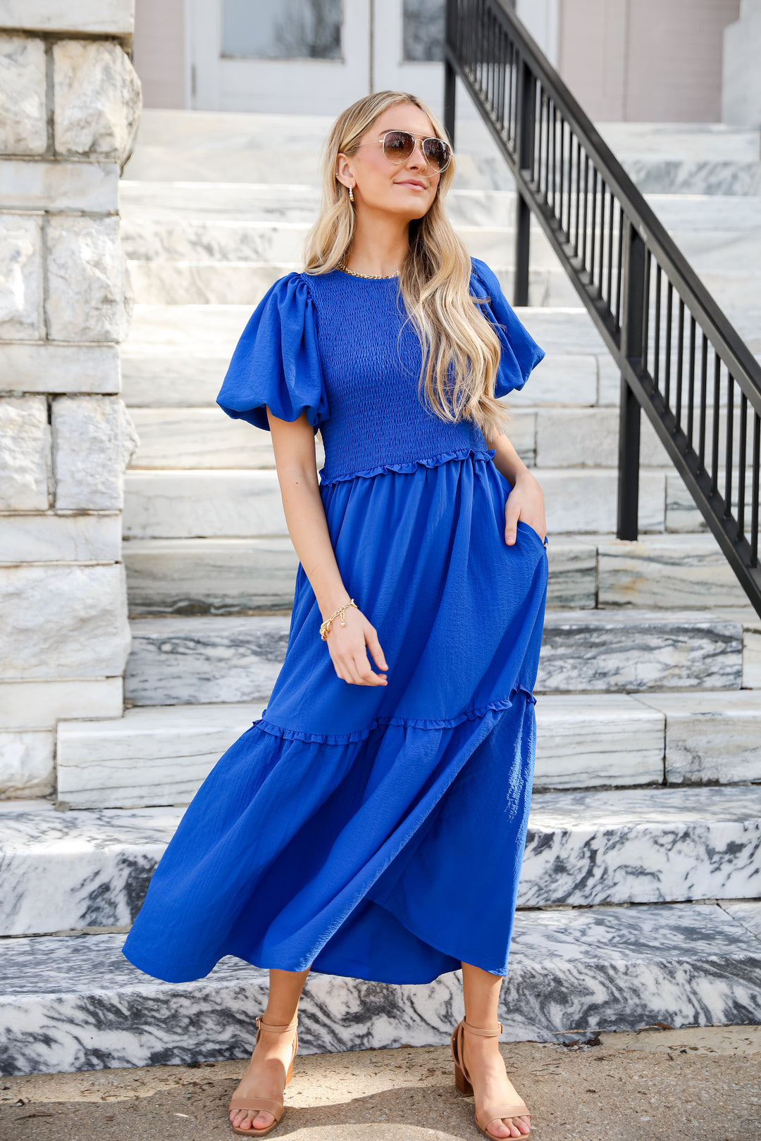 model wearing a flowy blue maxi dress