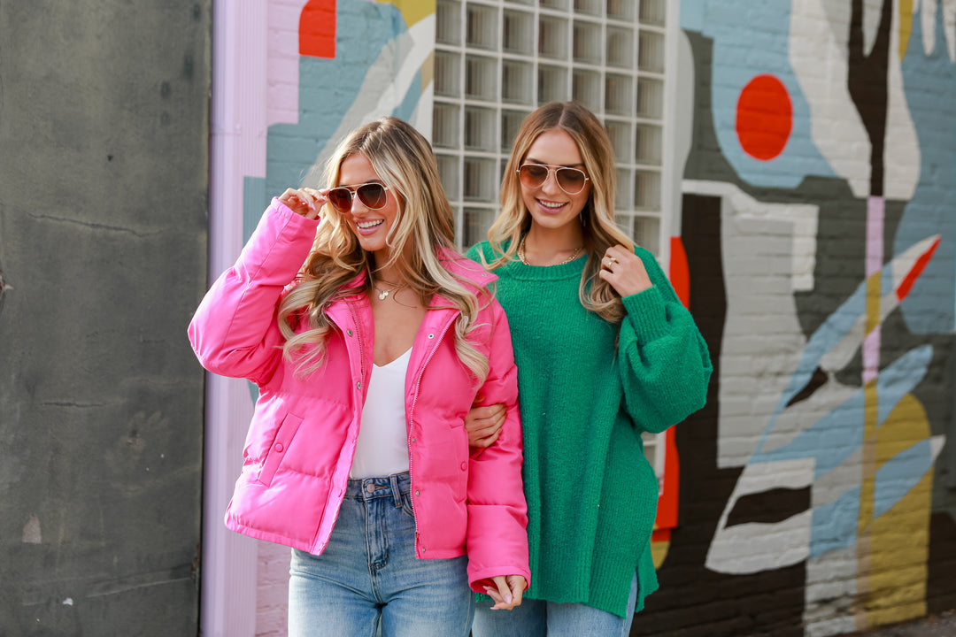 two models wearing bright colored tops in the winter