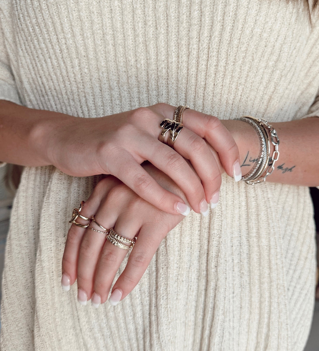 hand model wearing stackable rings and bracelets