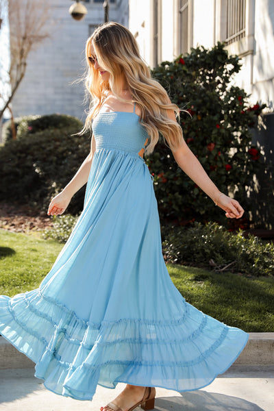 One model wearing blue maxi dress. online dress boutique. women's boutique. maxi free people inspired dress