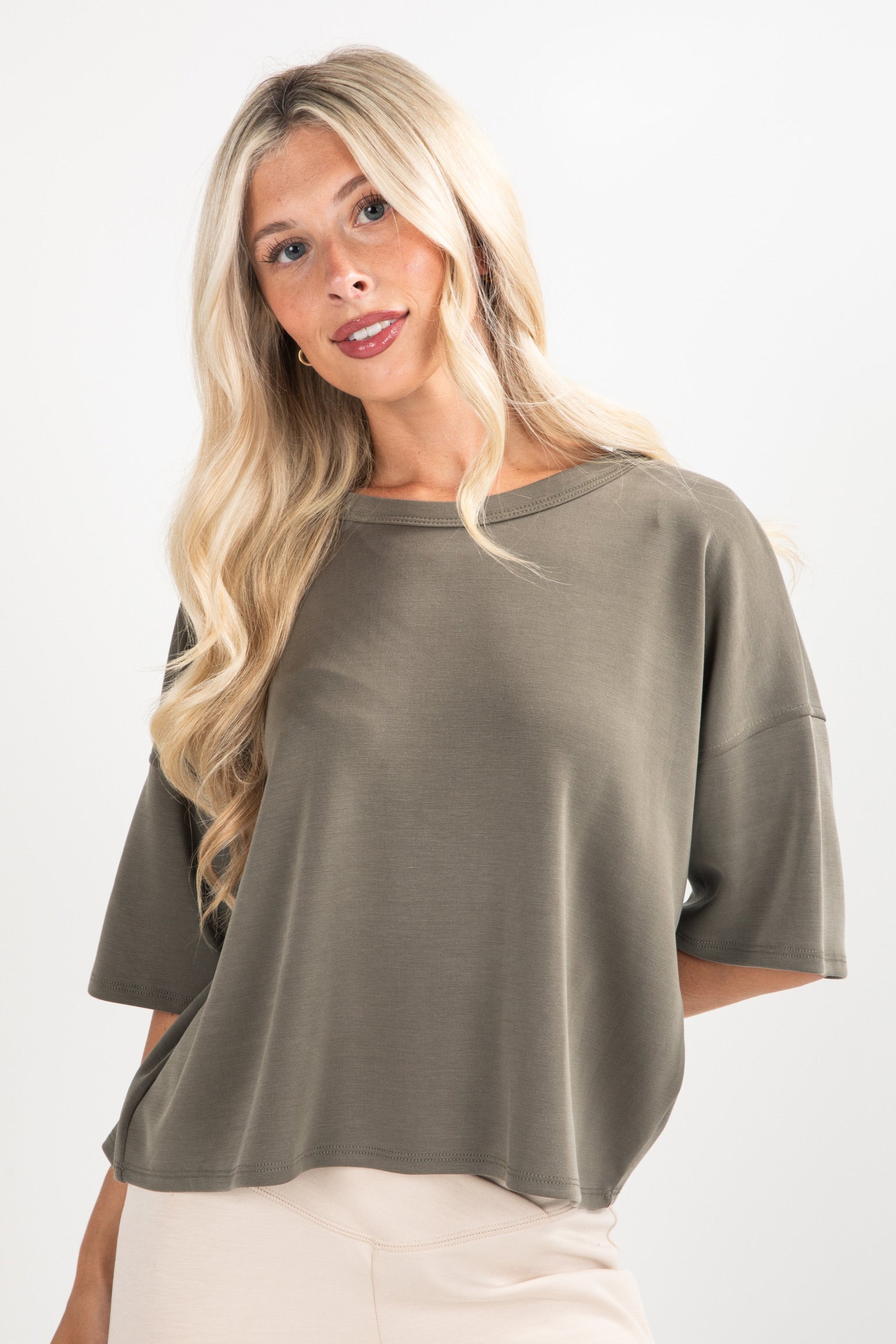 Woman wearing a green sweater on a white background