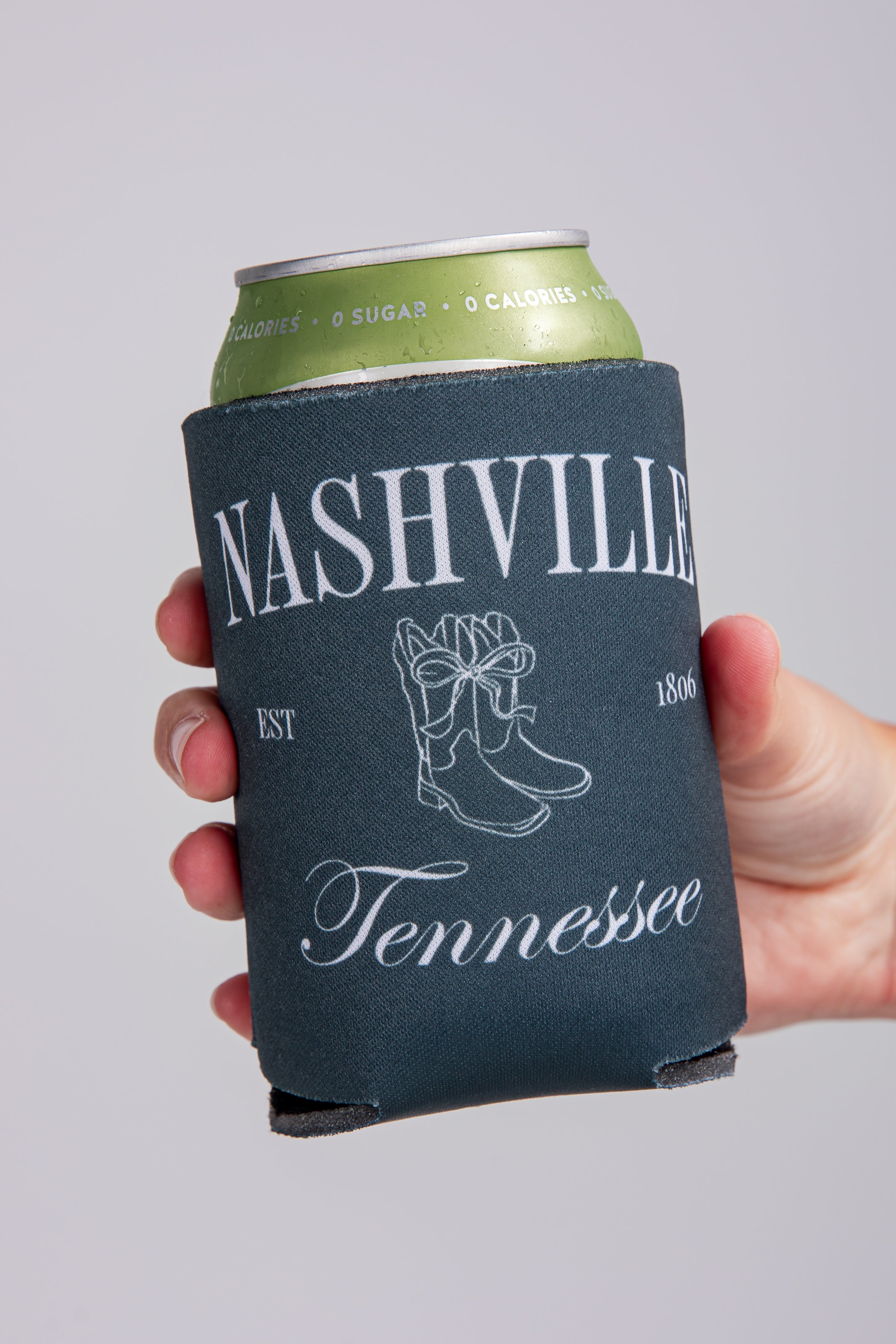 Can with a Nashville, Tennessee-themed can cooler on a gray background
