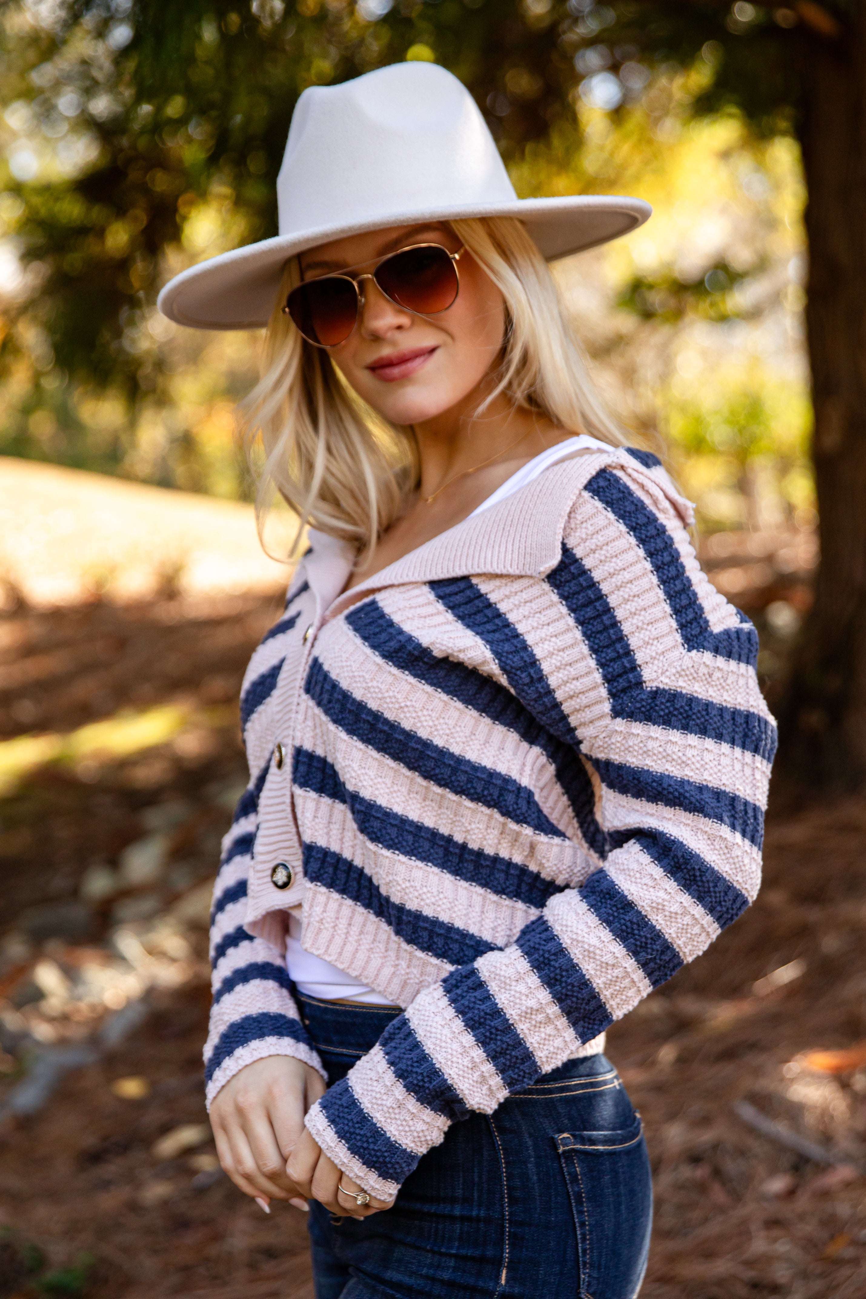 Woman wearing a striped sweater and hat outdoors
