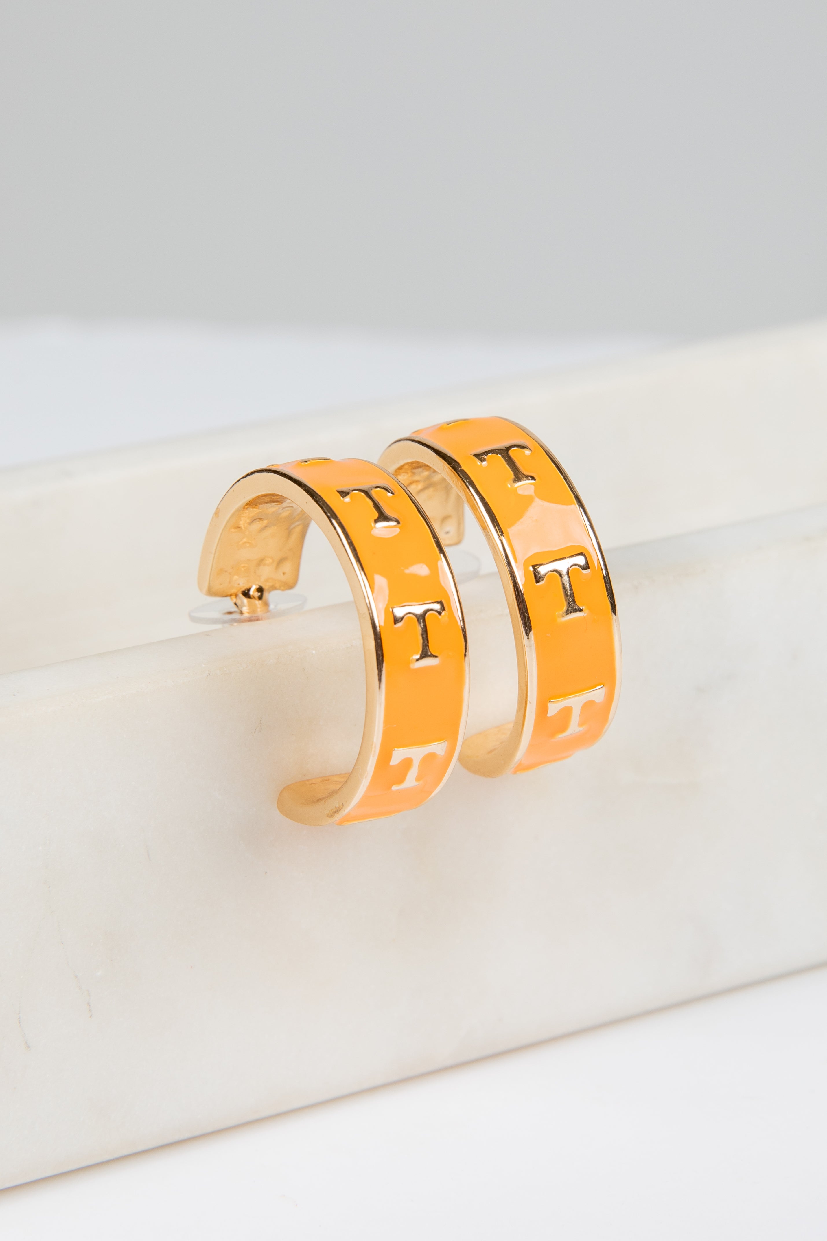 Pair of gold hoop earrings with &