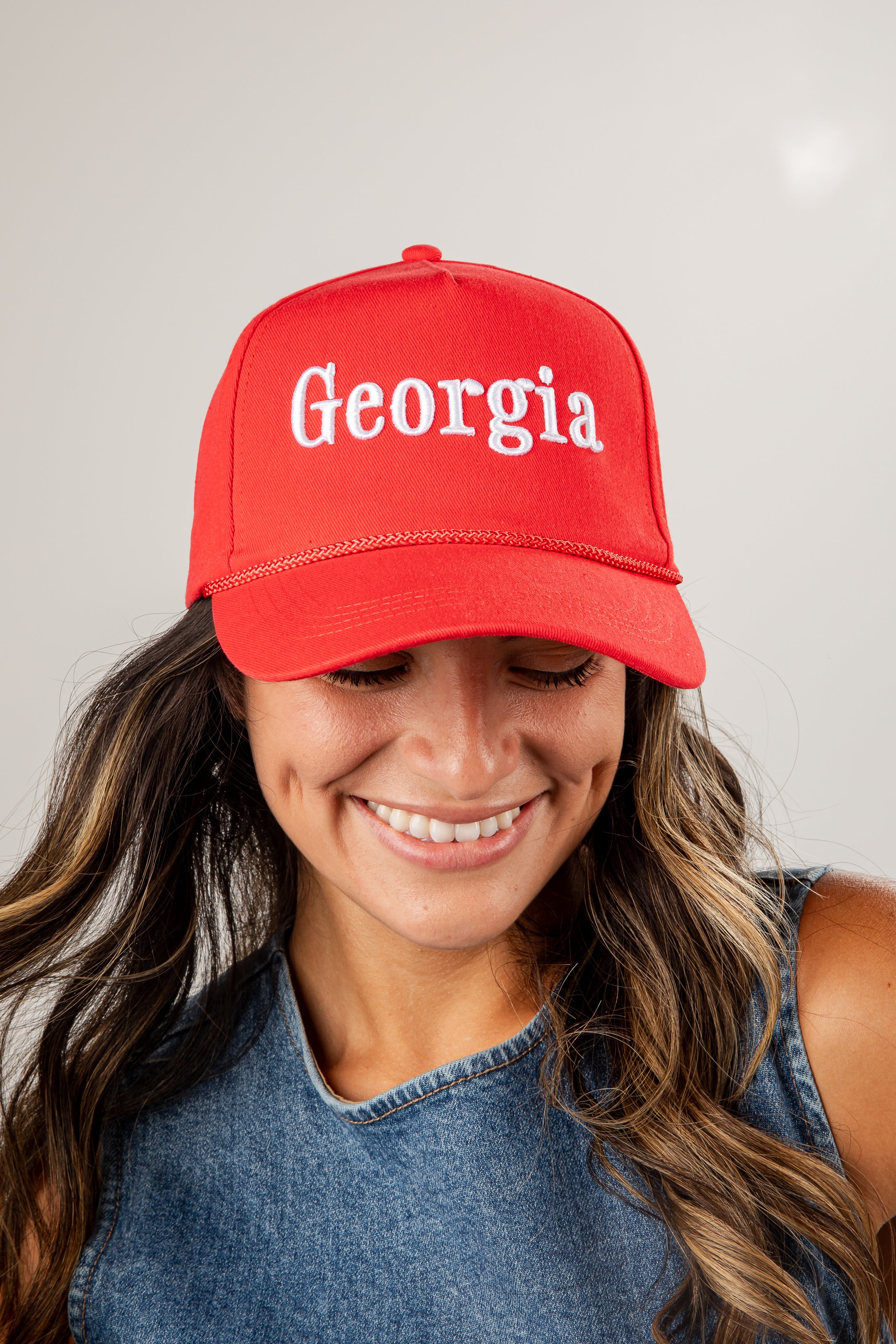 Person wearing a red cap with &