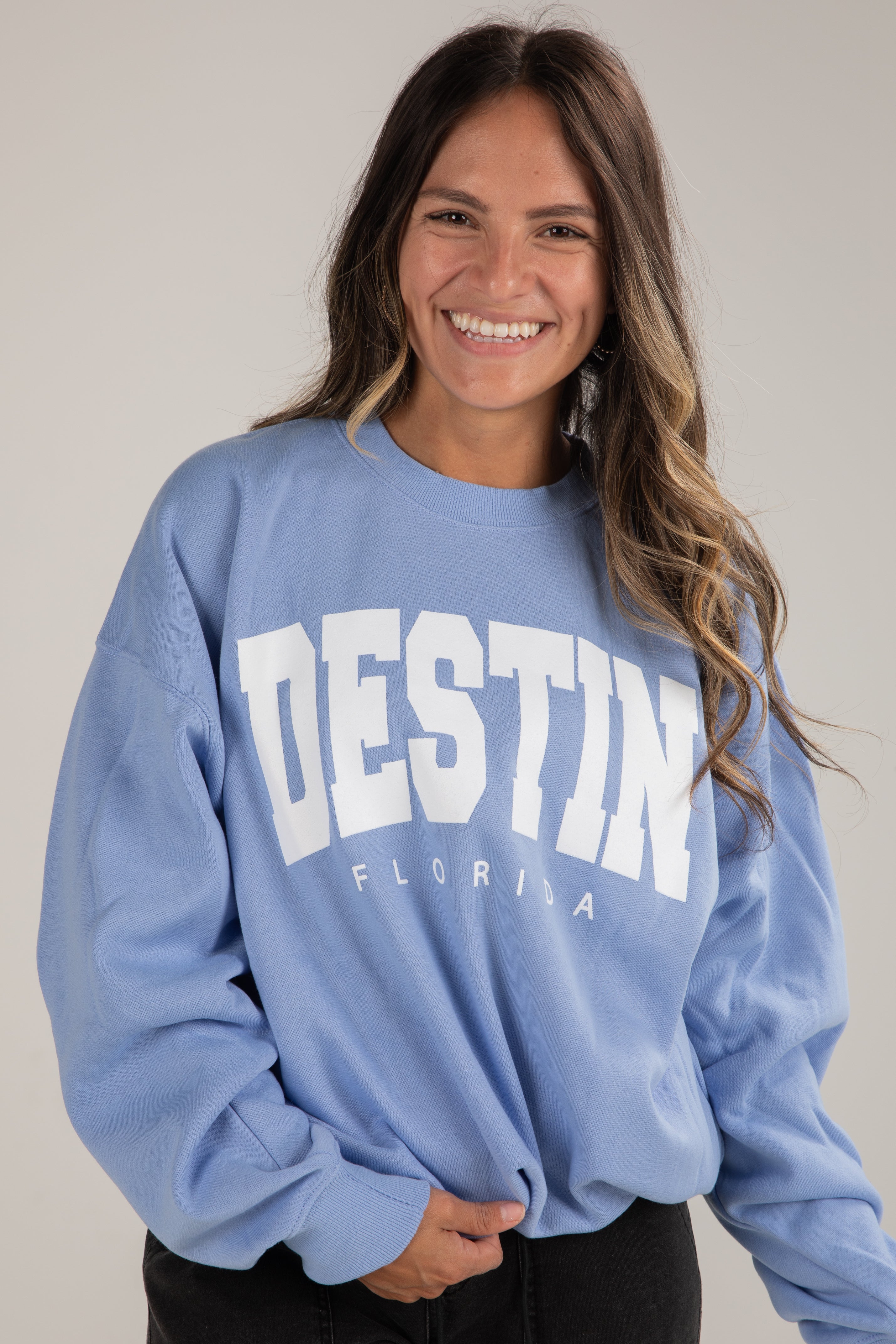 Woman wearing a blue sweatshirt with &