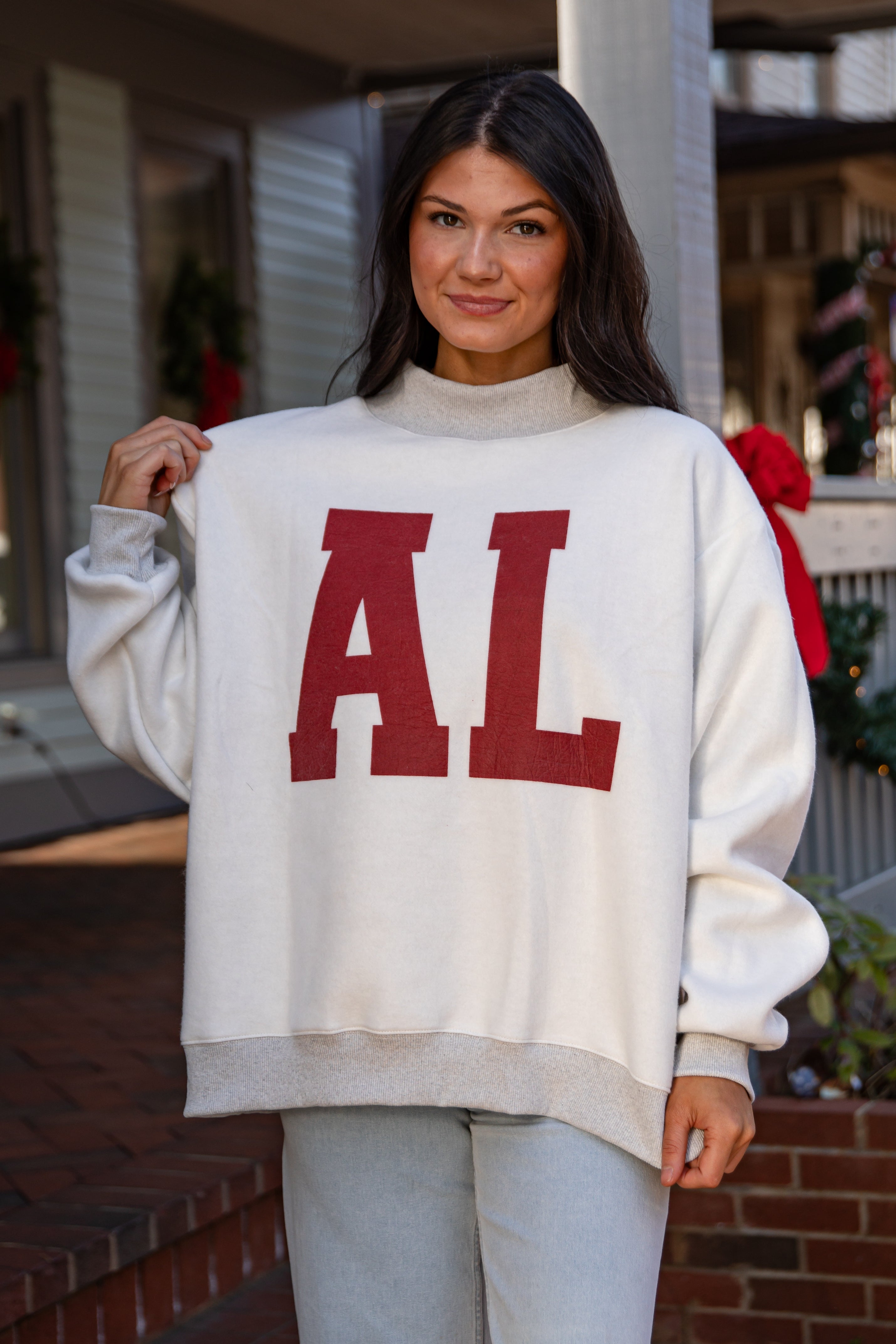 Woman wearing a white sweater with &