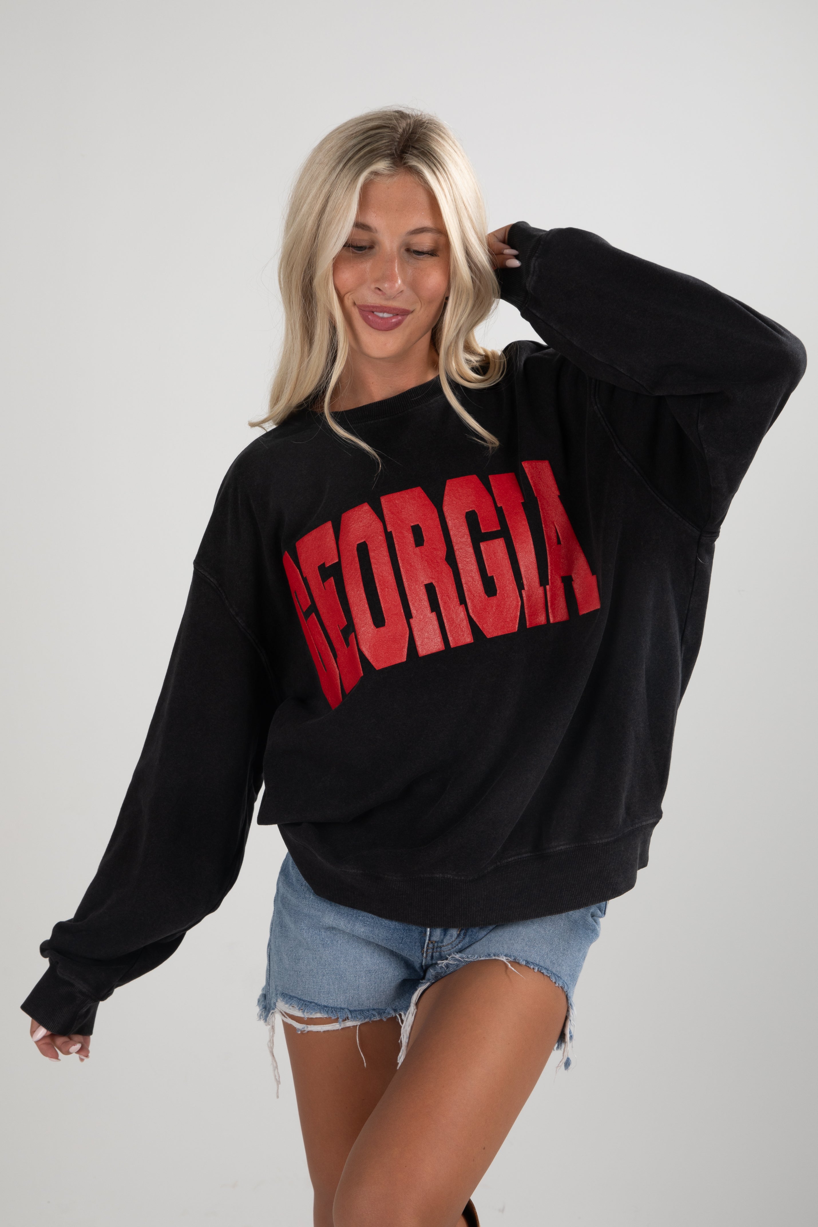 Woman wearing a black sweatshirt with &