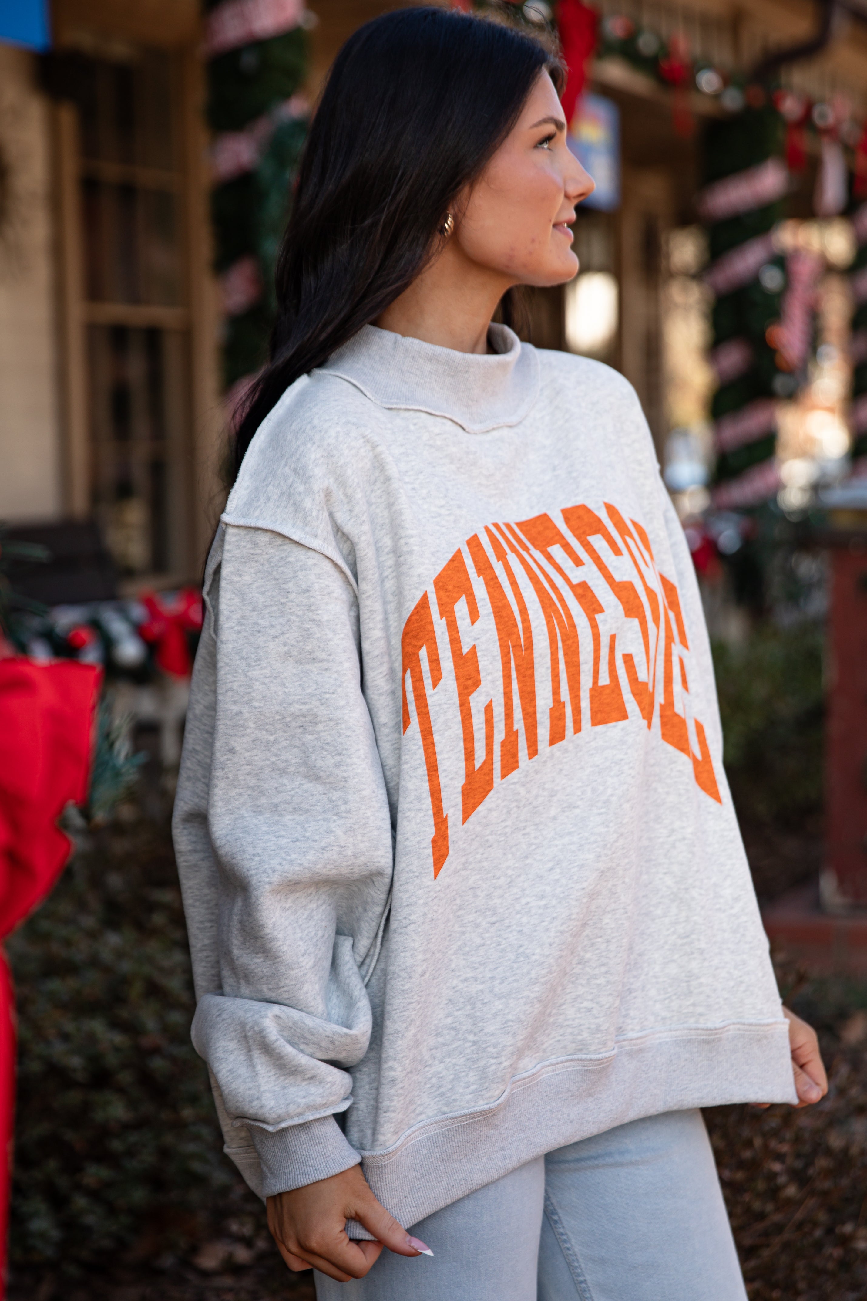 Person wearing a gray sweatshirt with &