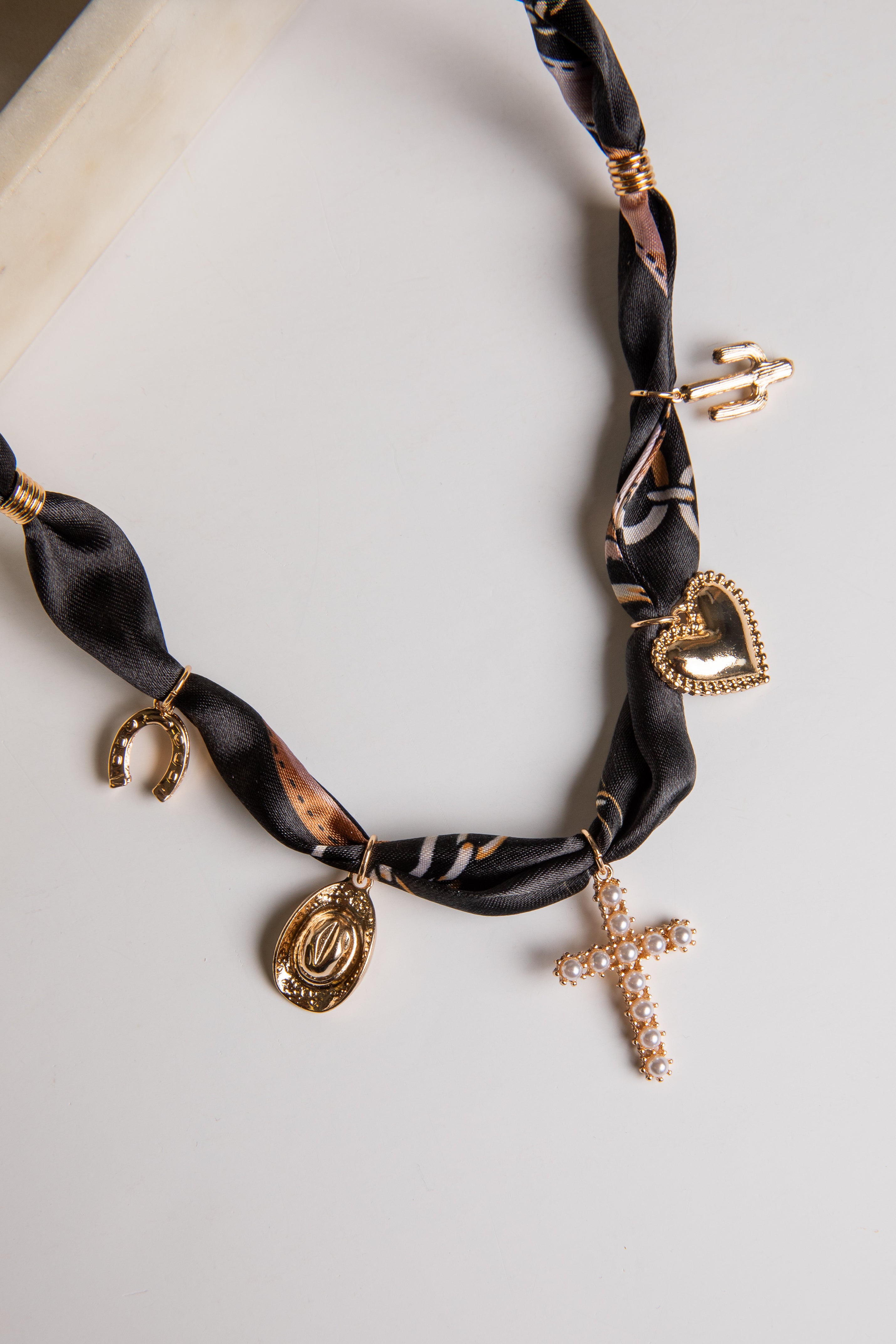 Necklace with gold charms on a white background