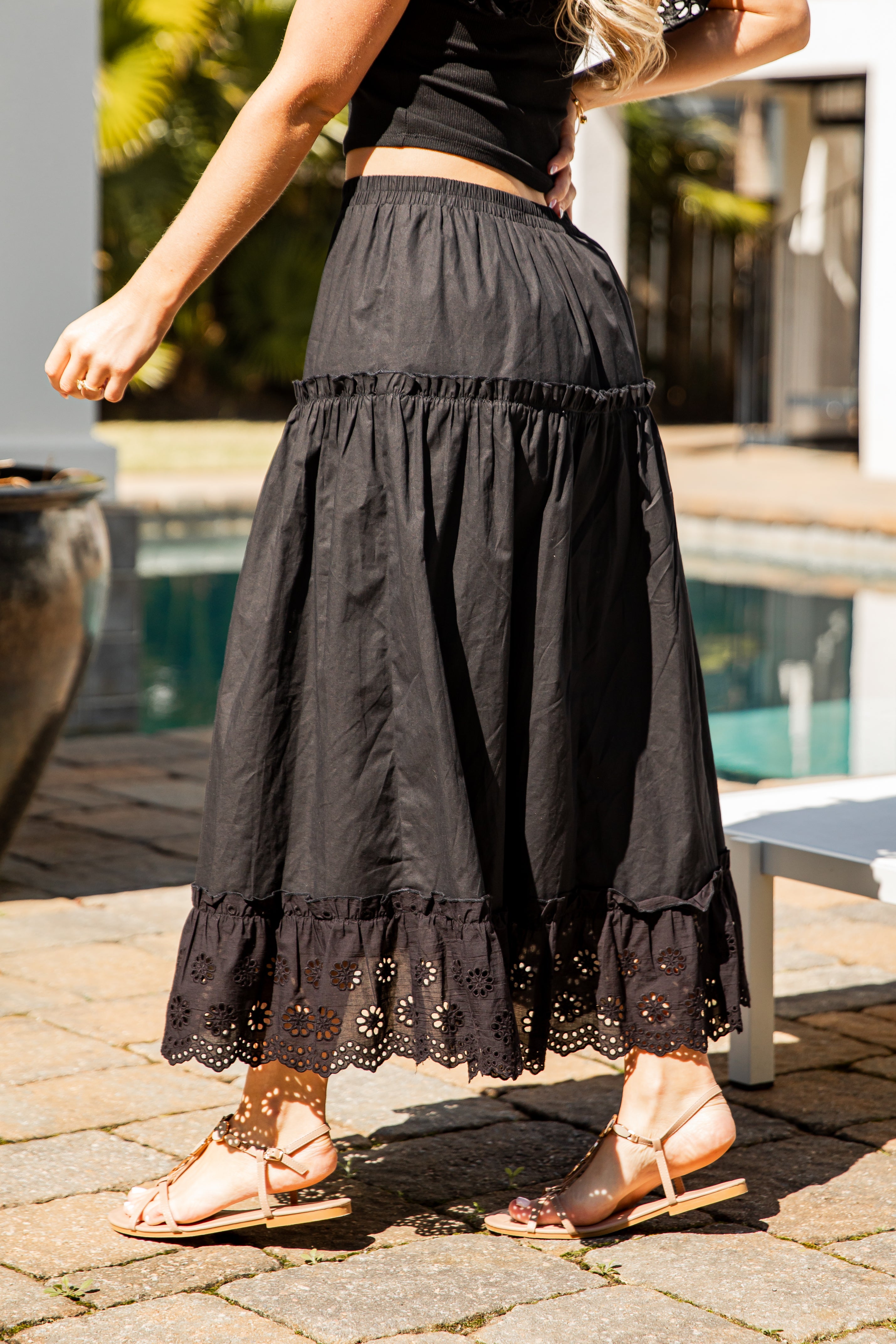 Black lace-trim maxi skirt walking shot