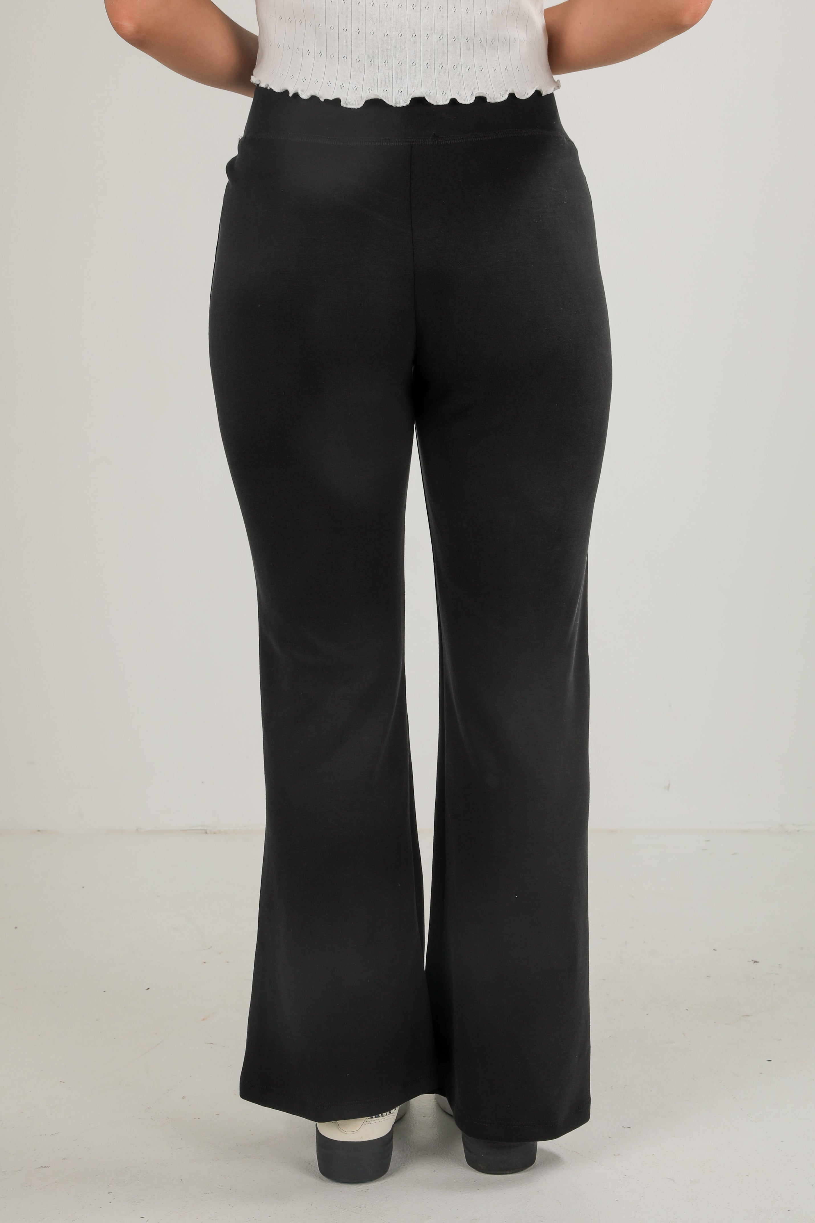 Black wide-leg pants worn by a person on a plain background