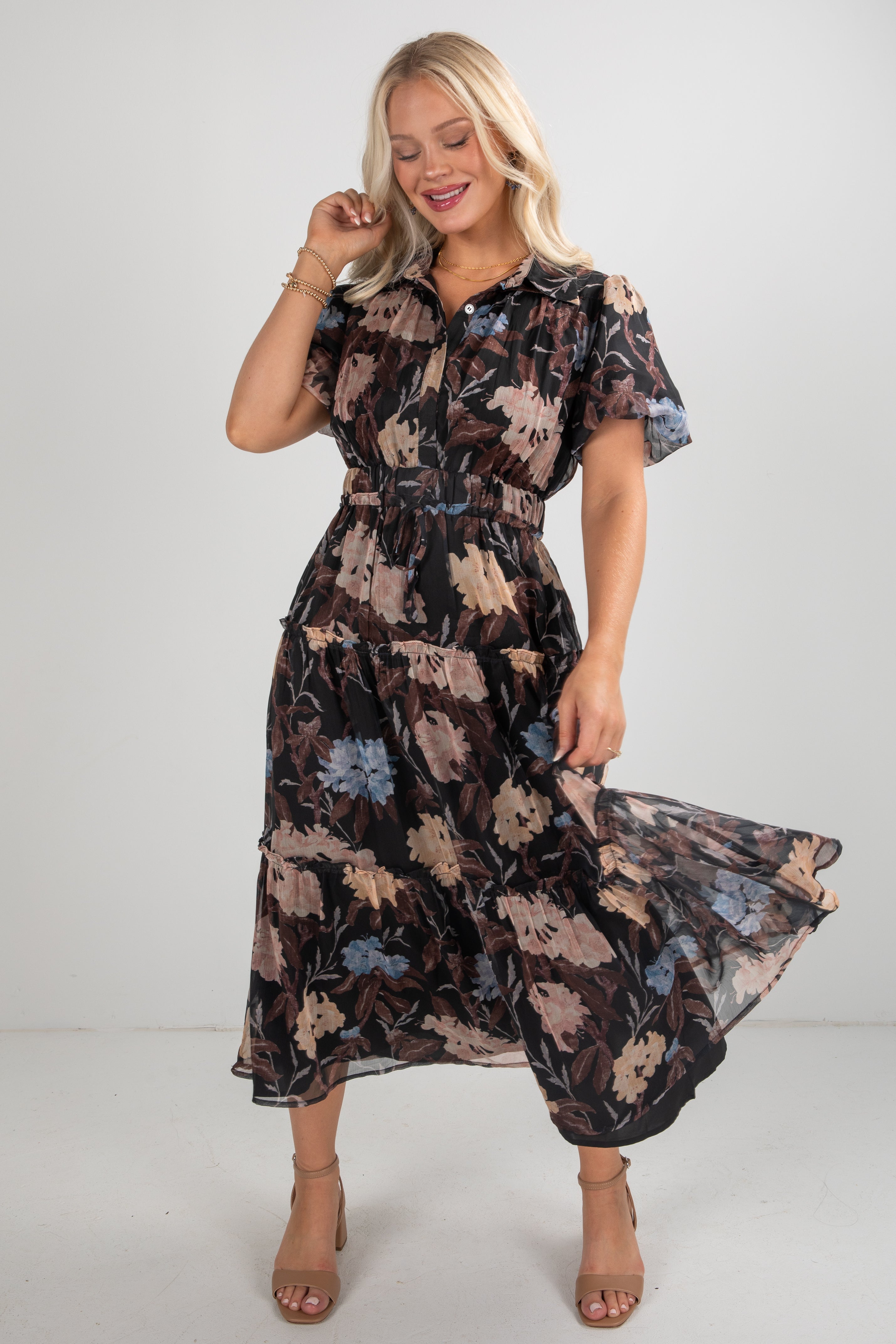 Woman wearing a floral dress on a plain background