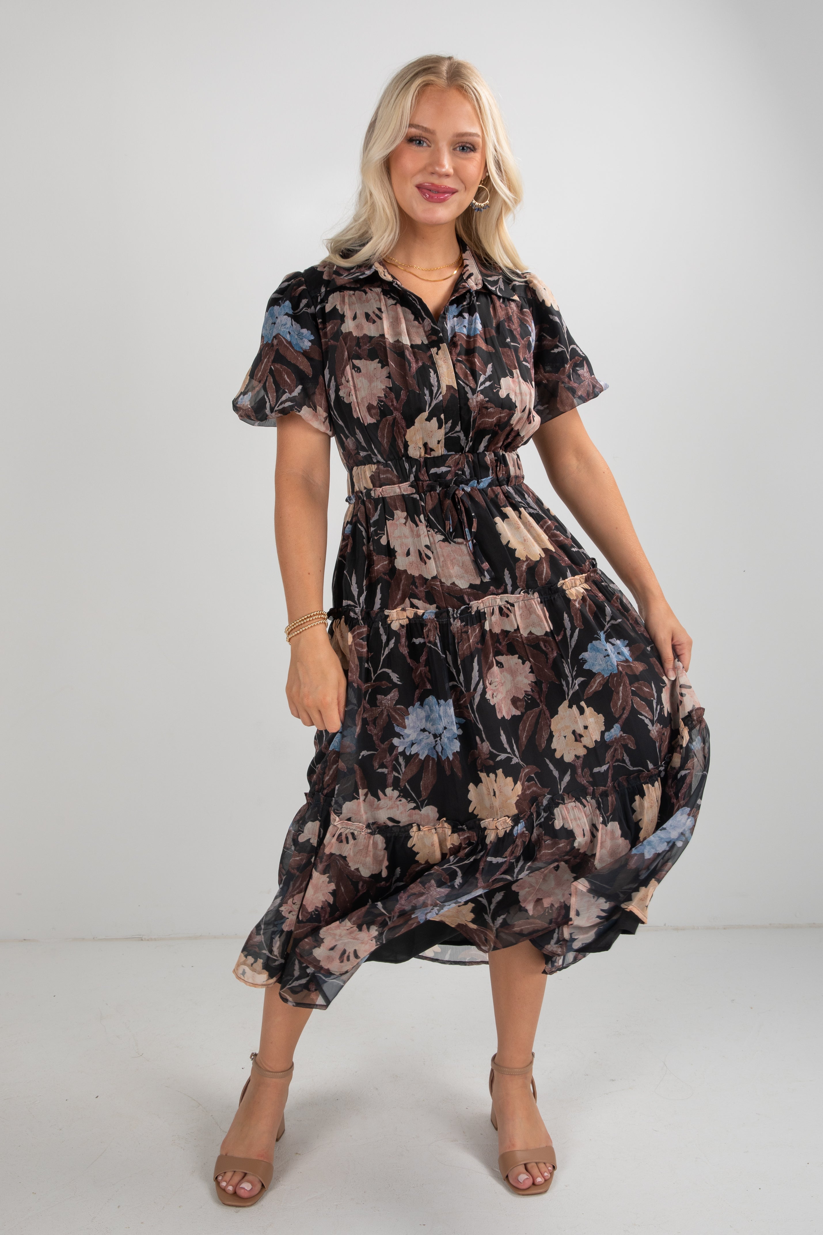 Woman wearing a floral dress on a plain background