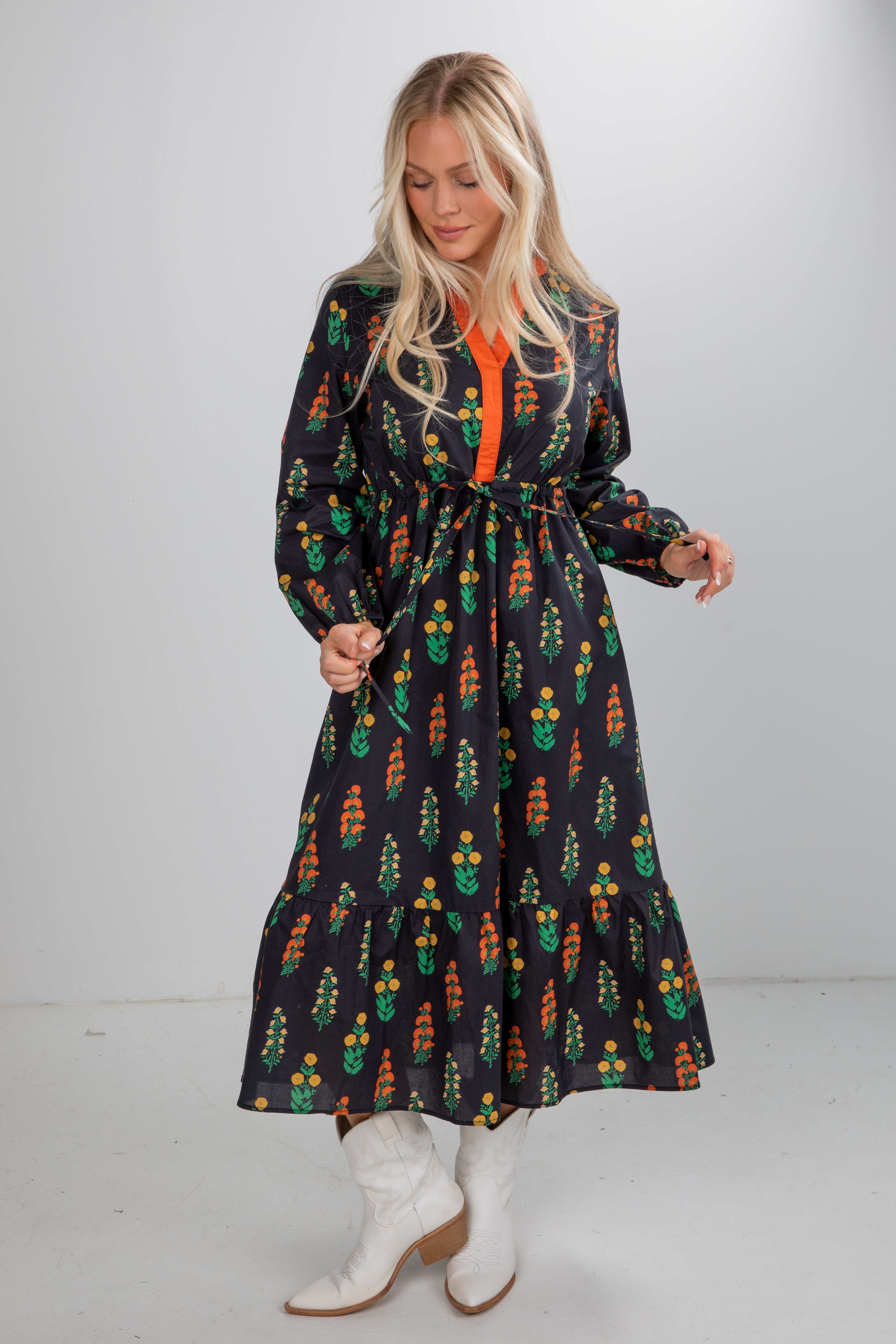 Woman wearing a patterned dress with a plain background