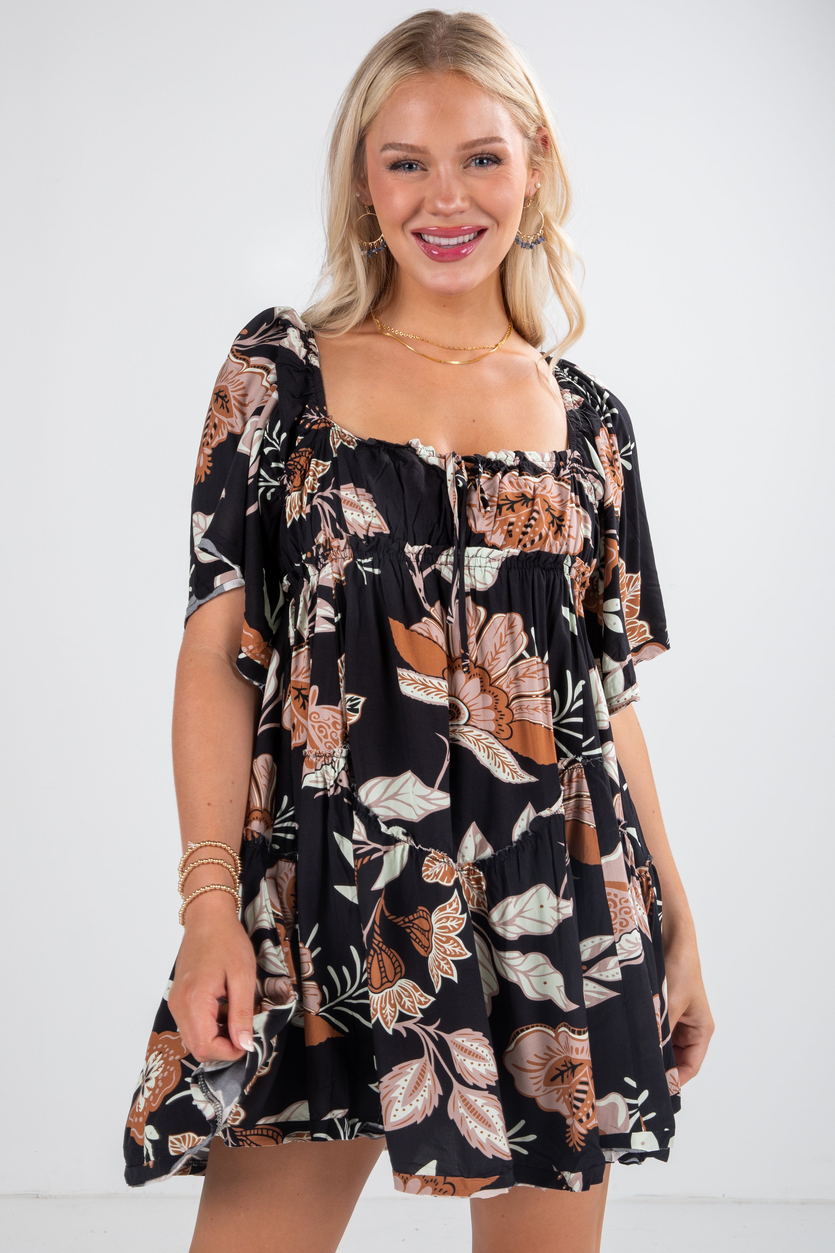 Woman wearing a black floral dress on a white background