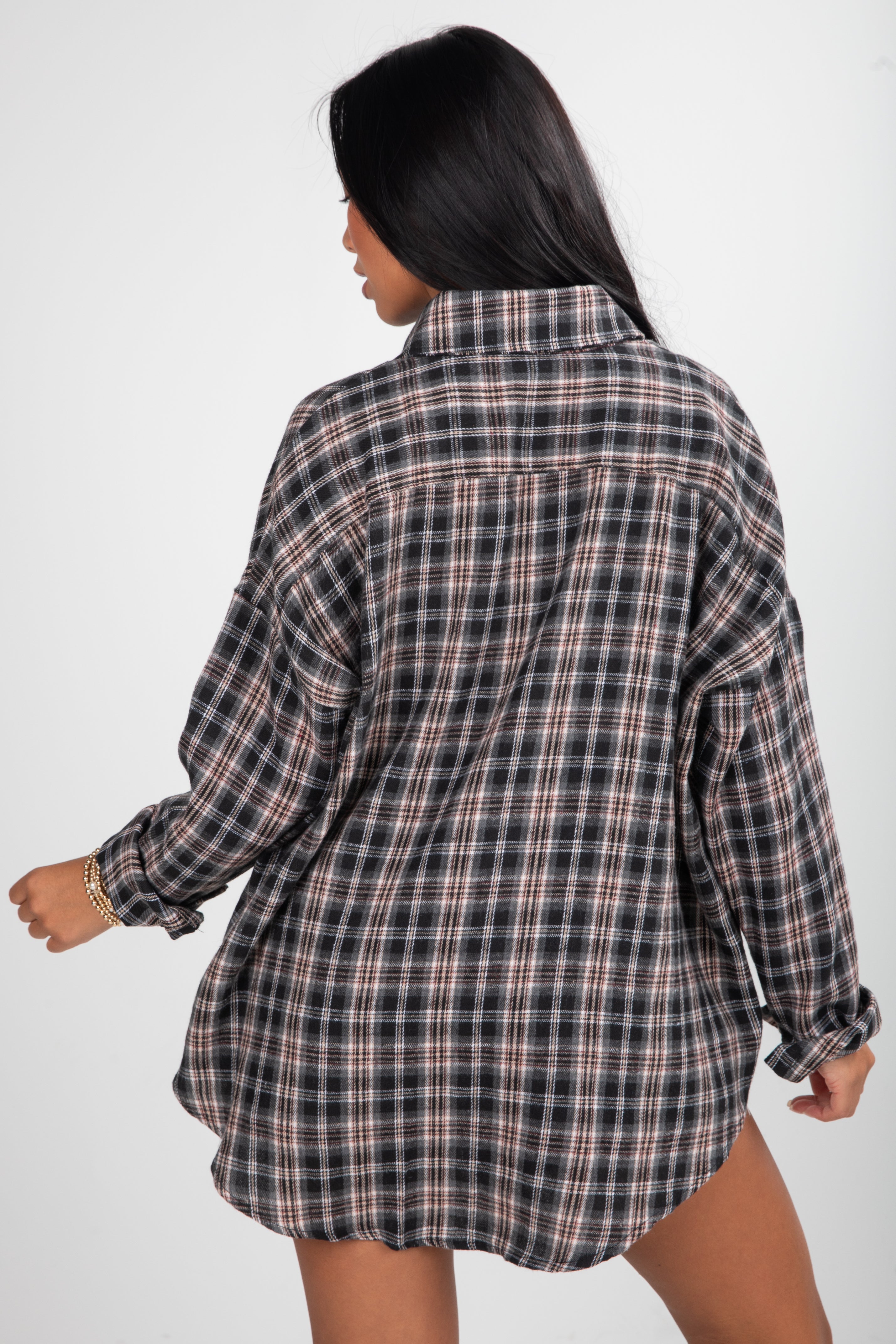 Person wearing a plaid shirt on a white background