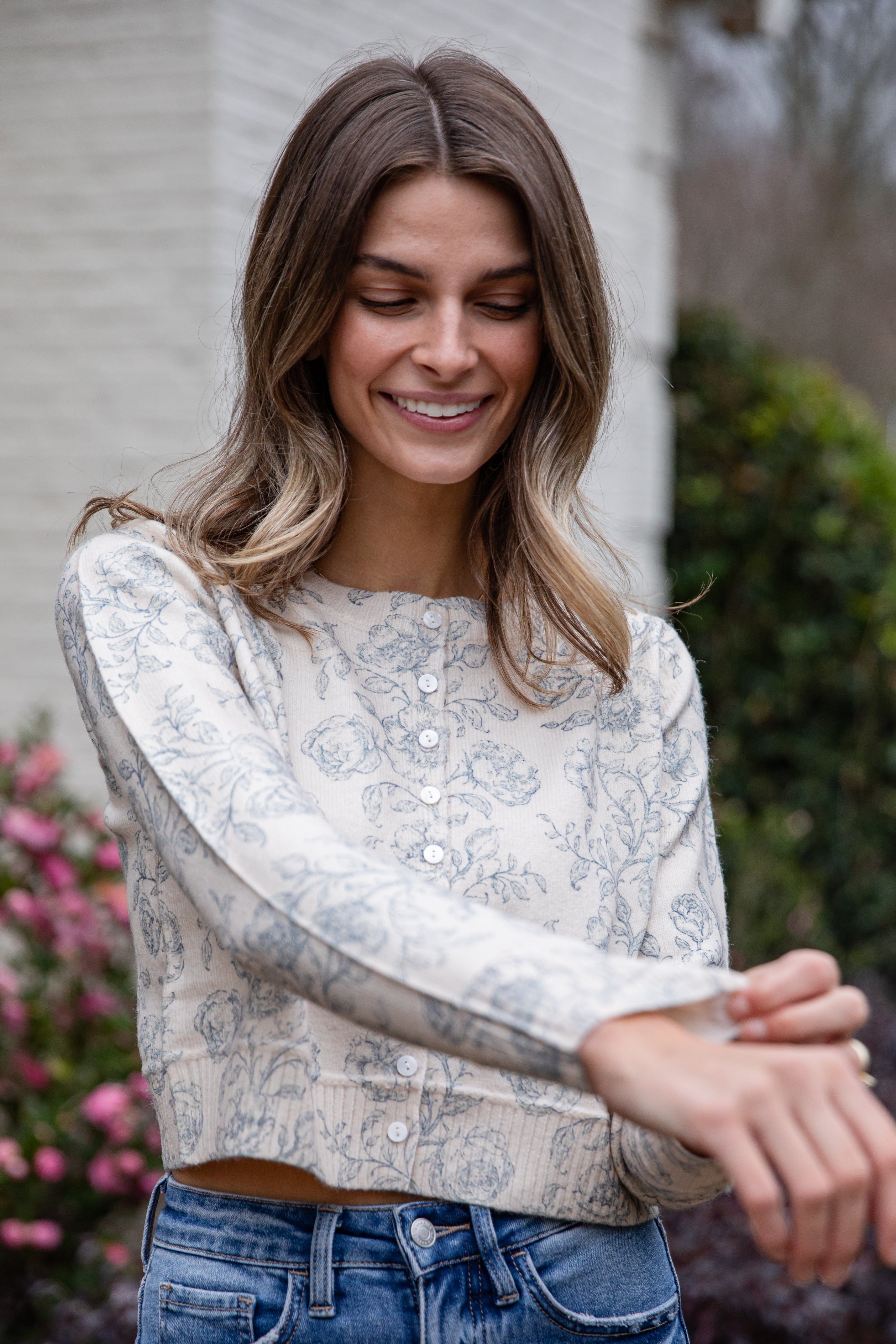 Woman wearing a floral blouse and jeans outdoors