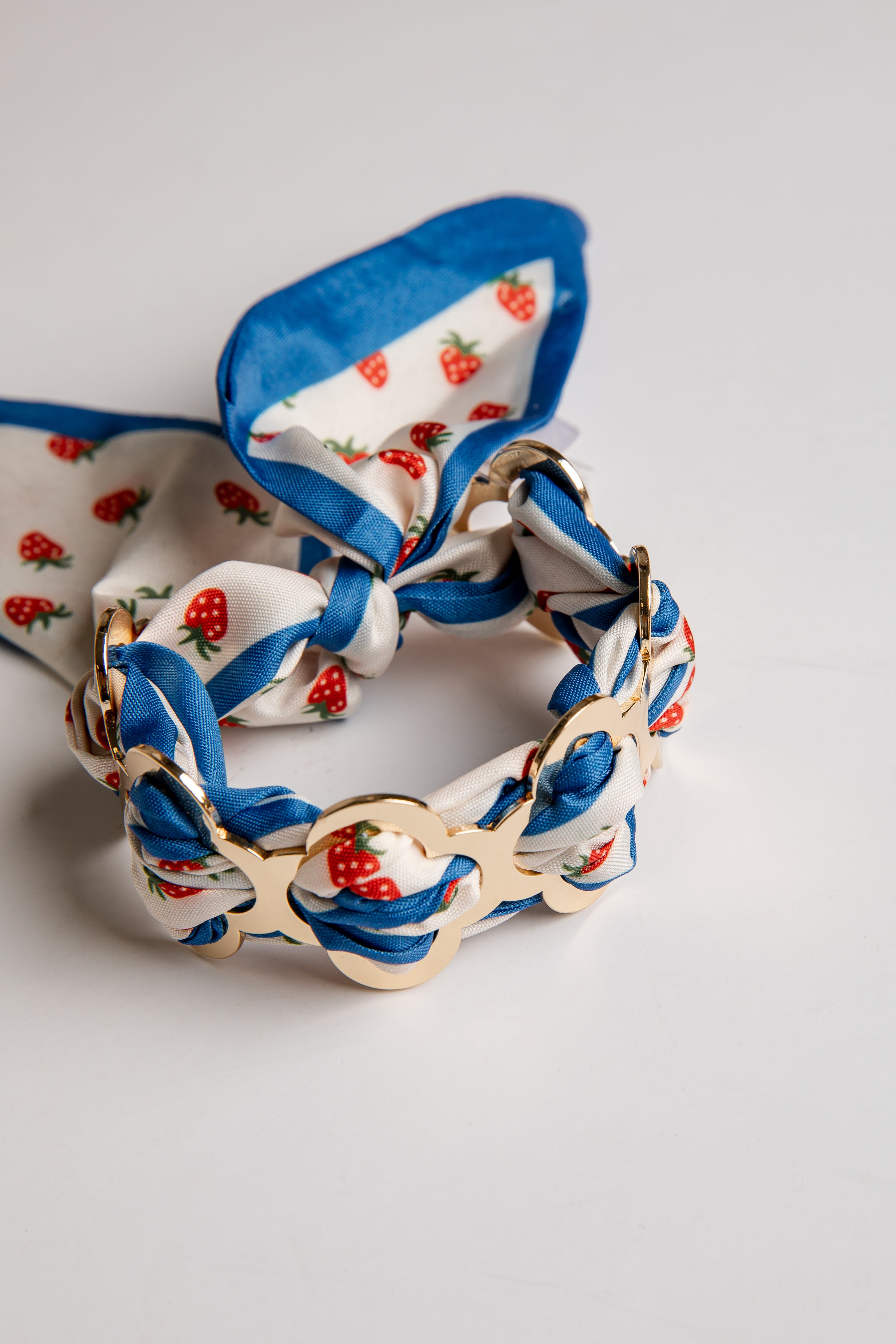 Braided bracelet with floral pattern on a light gray background