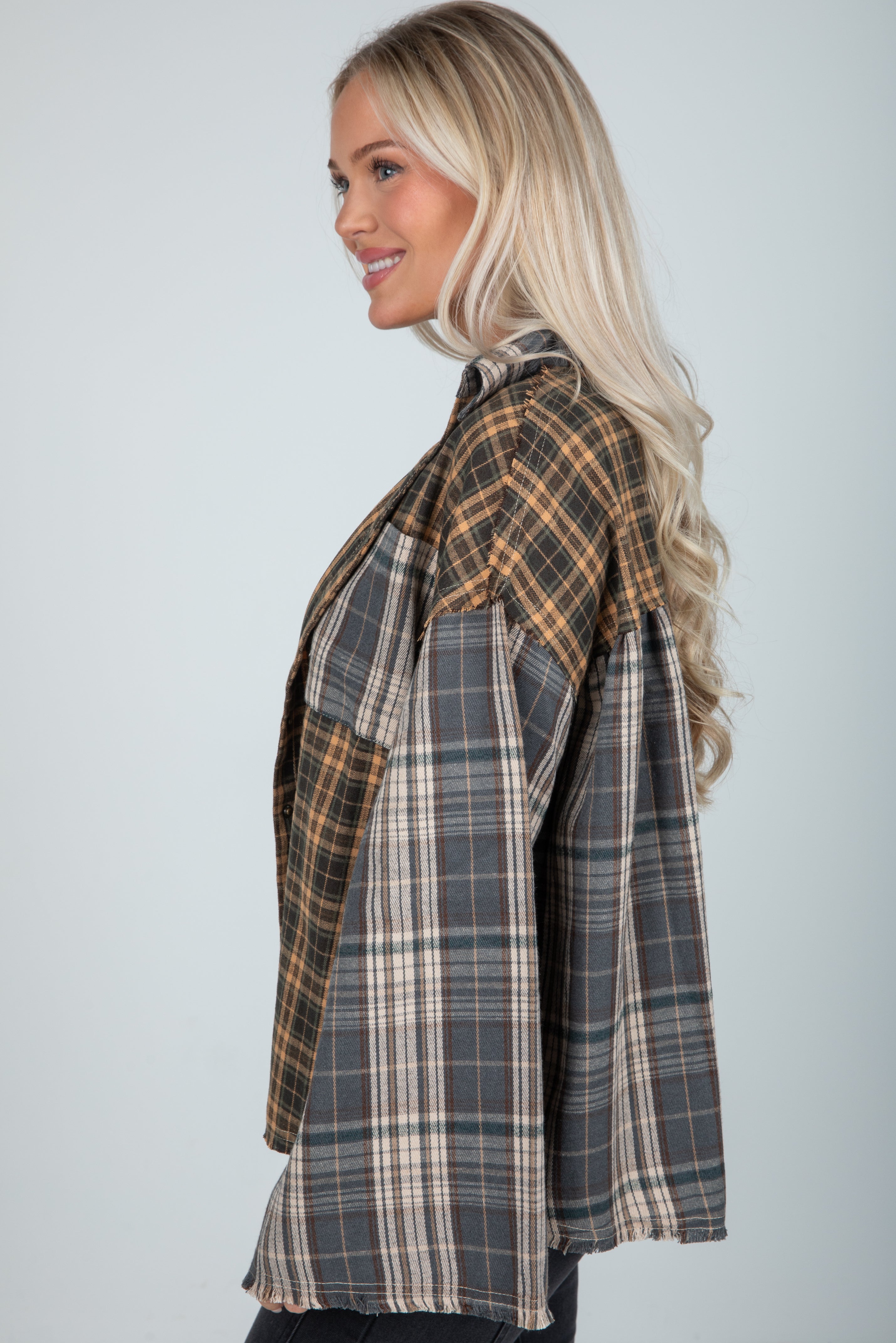 Woman wearing a plaid shirt against a plain background