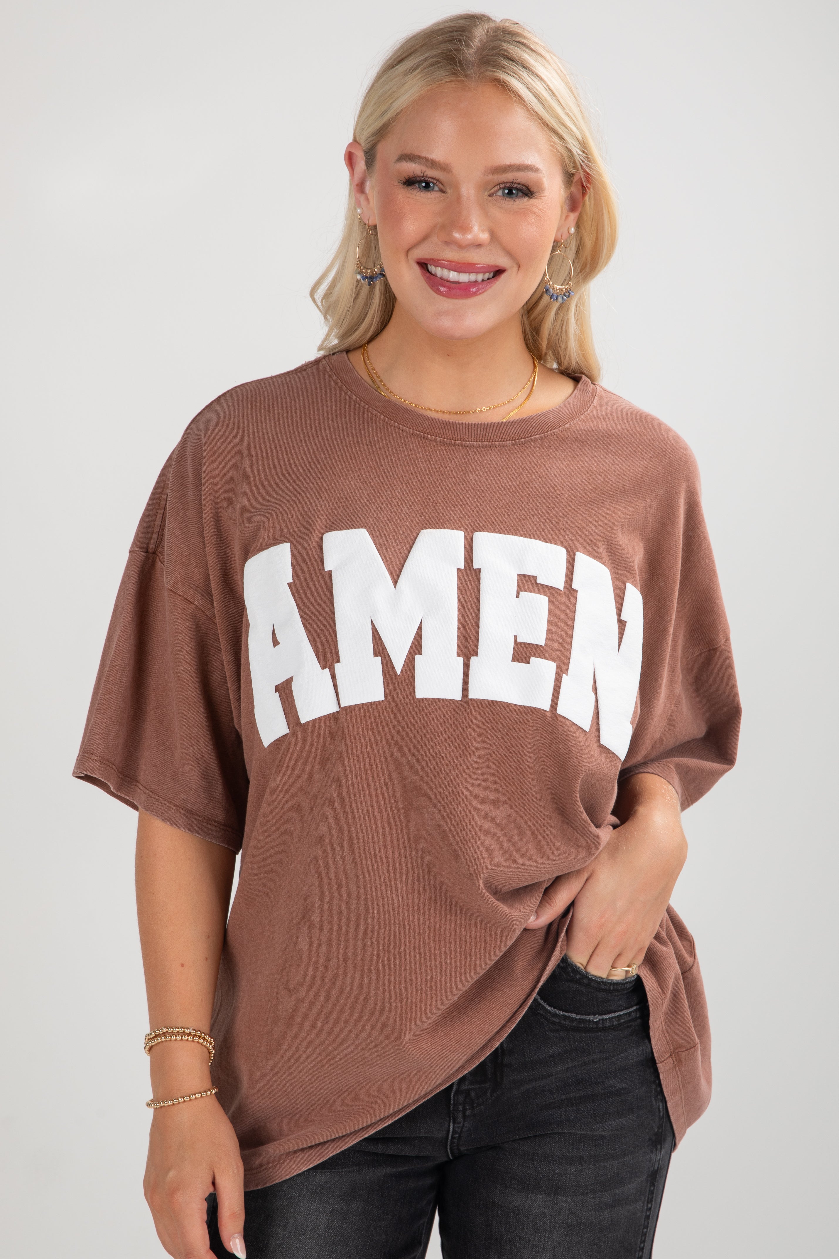 Woman wearing a brown t-shirt with &