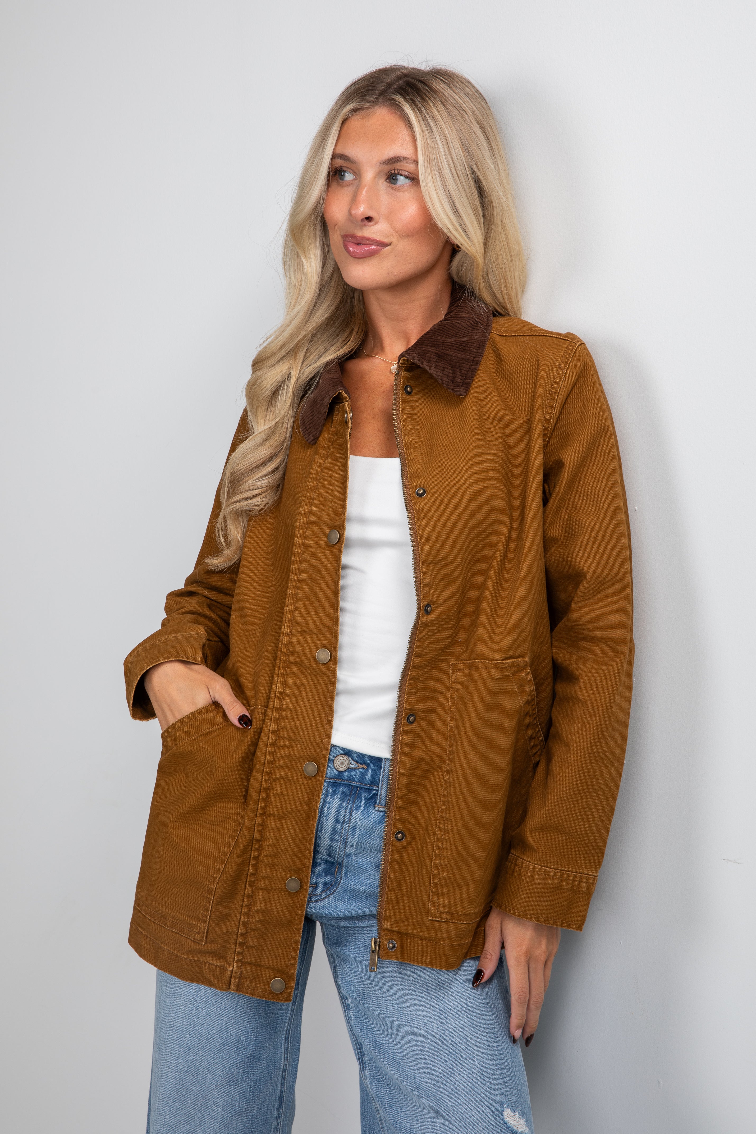 Woman wearing a brown jacket with a white background