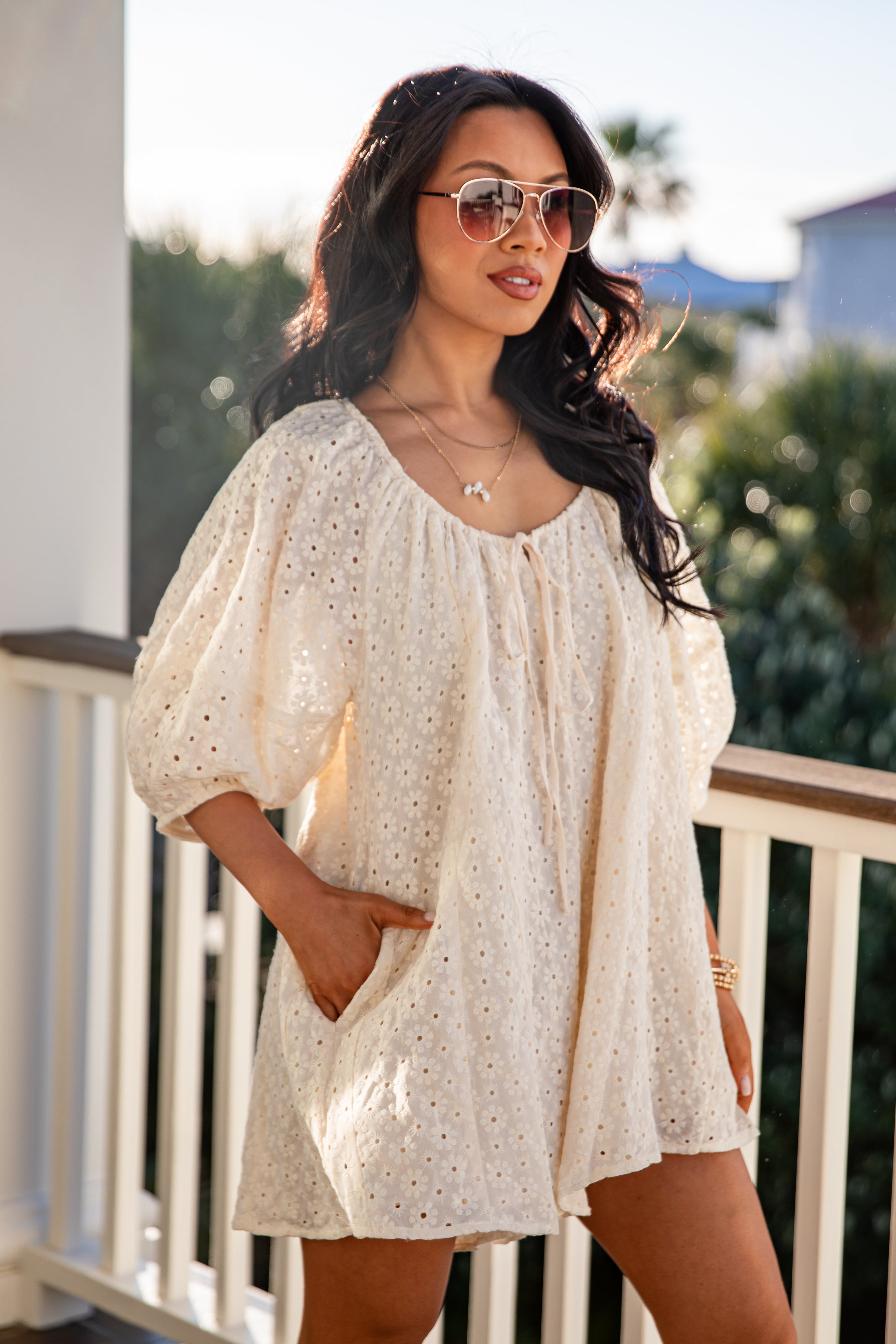Woman wearing a white blouse with puff sleeves on a balcony