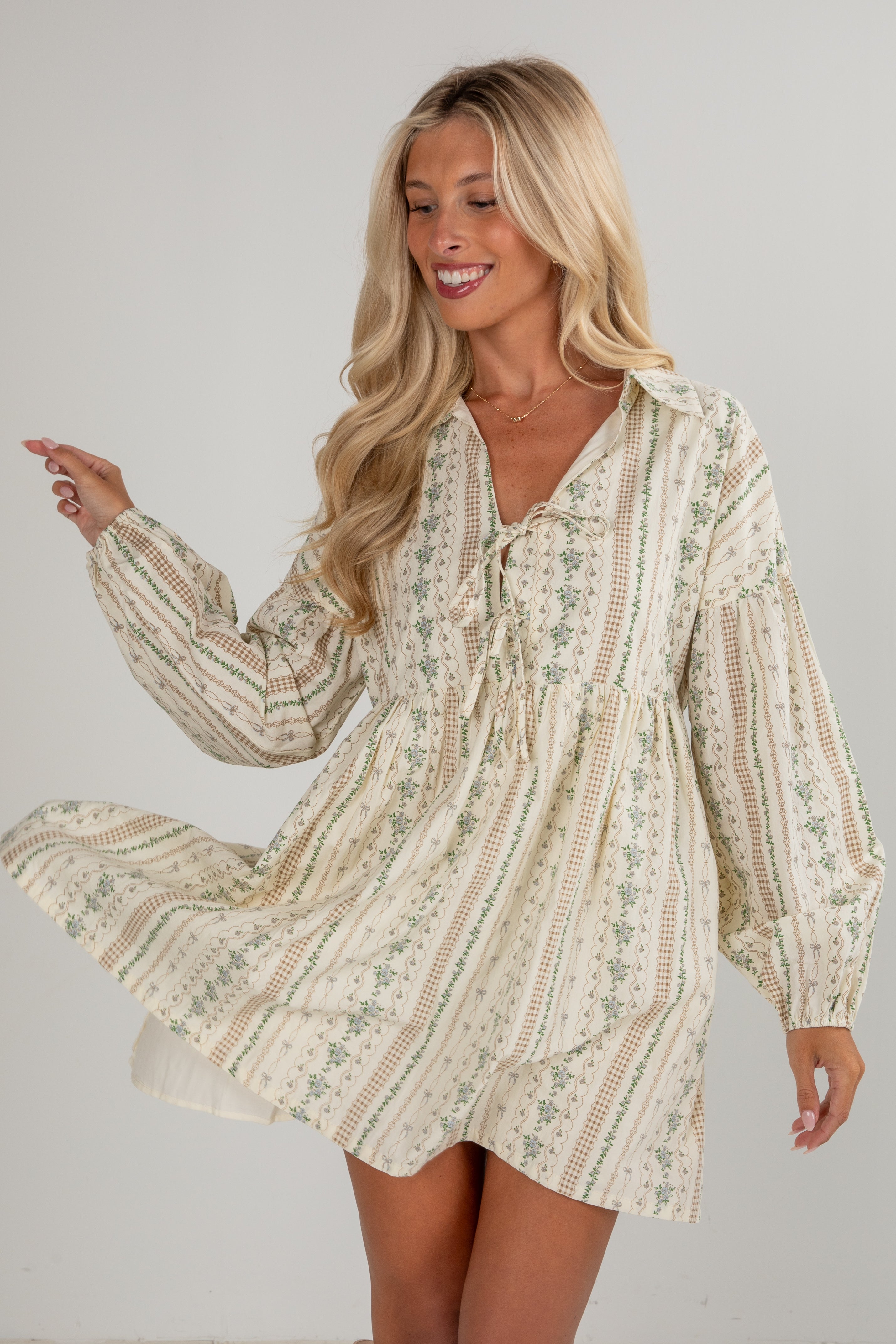 Woman wearing a floral dress against a plain background