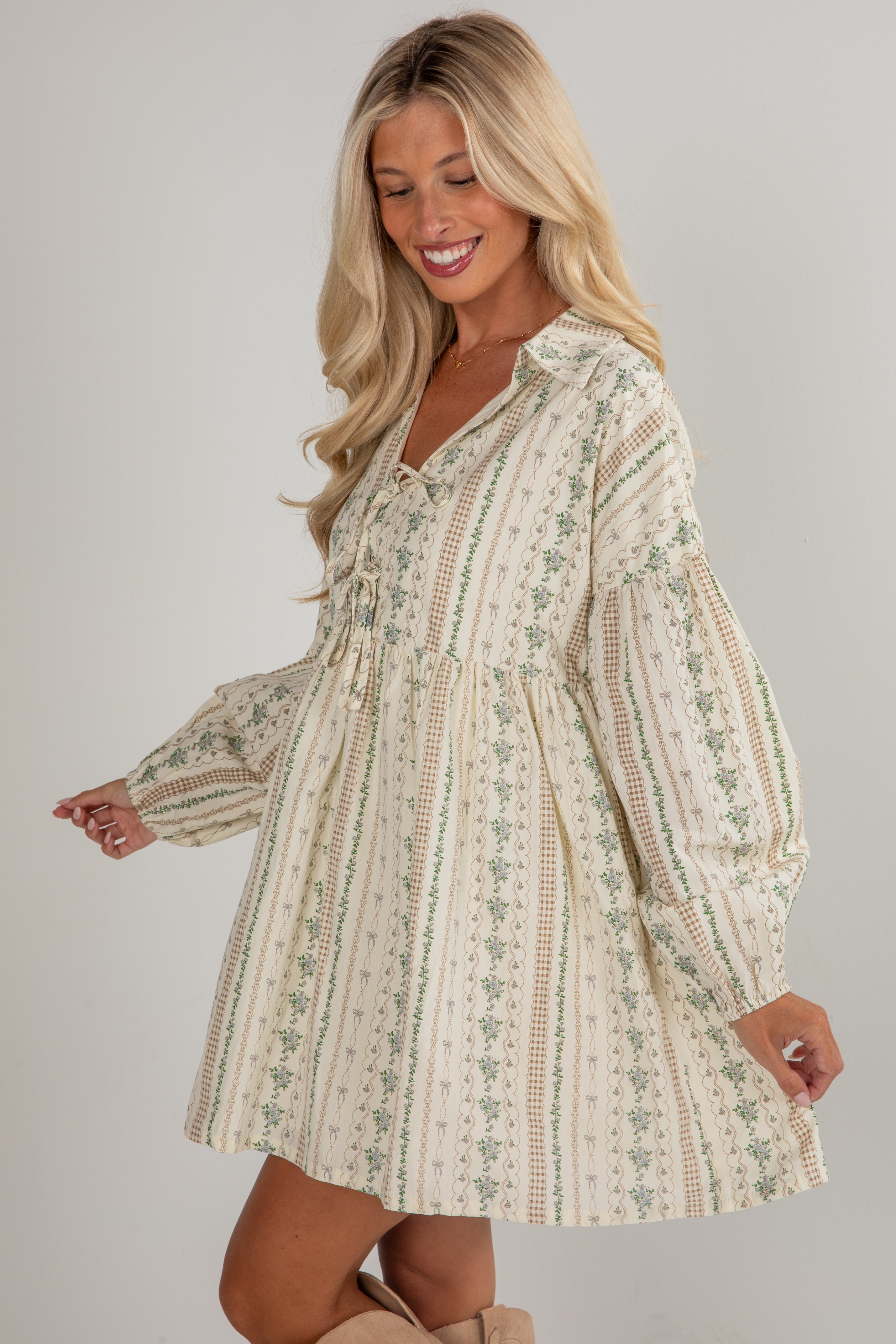 Woman wearing a floral dress against a plain background