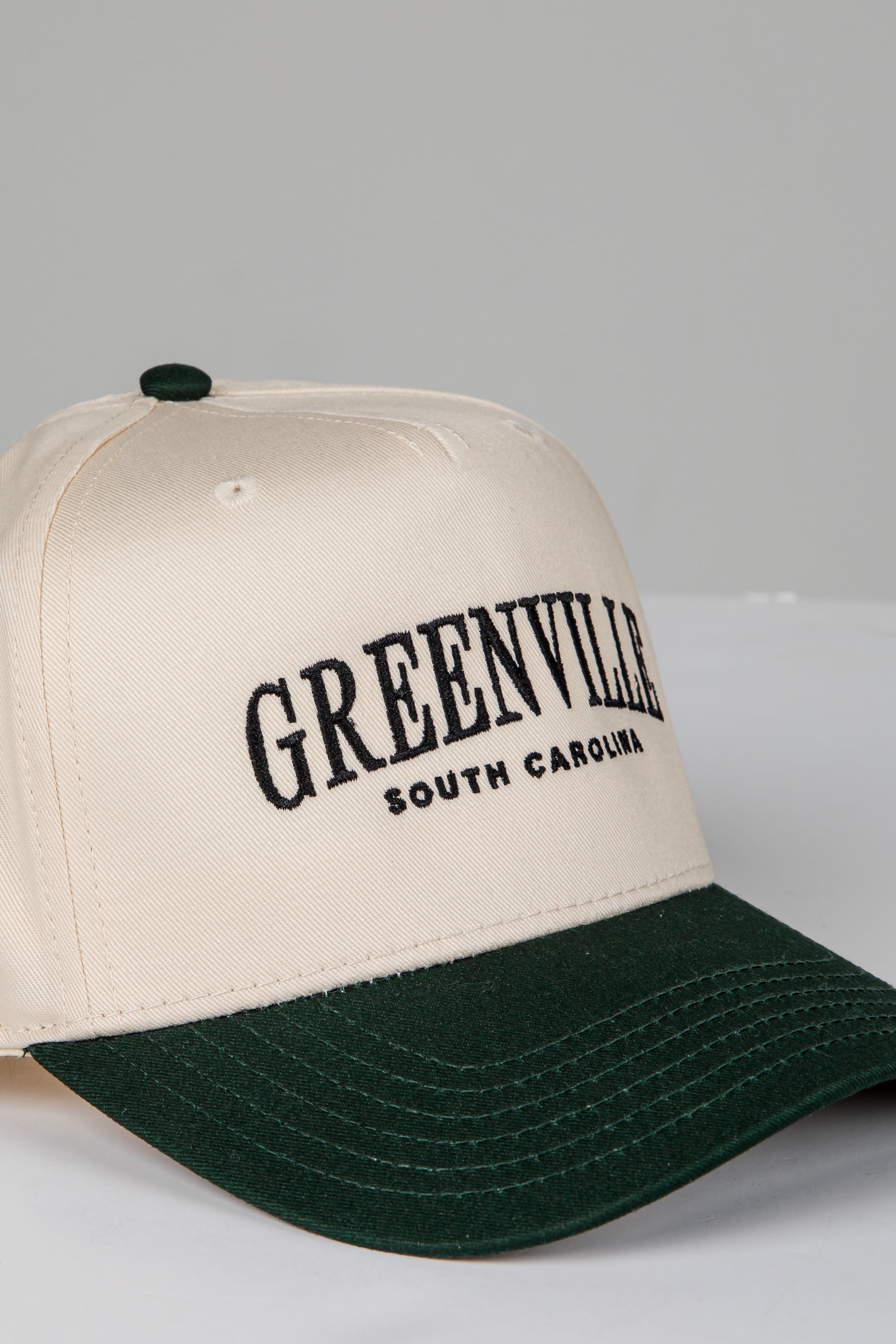 Beige and green cap with &