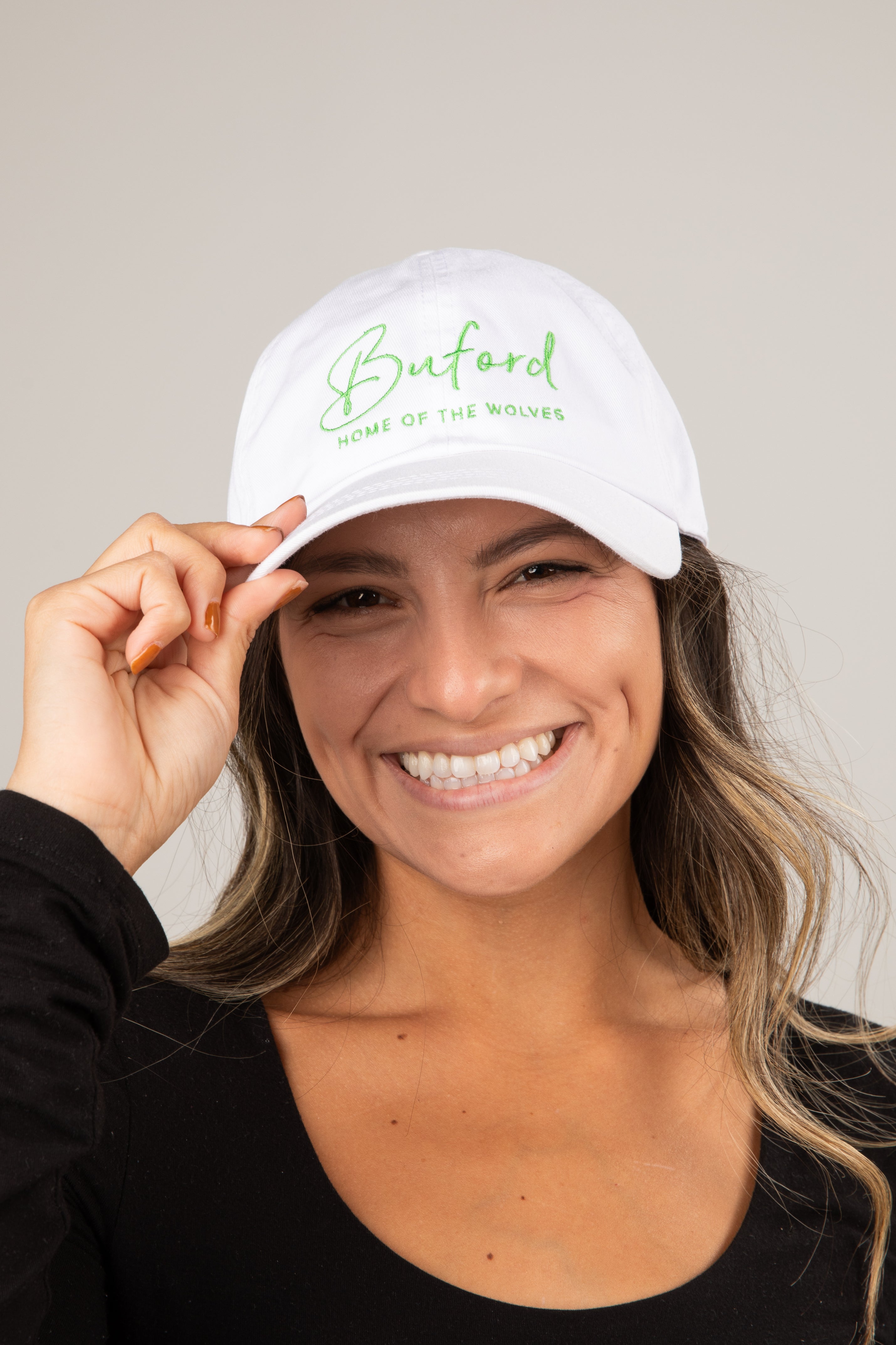 Woman wearing a white cap with &