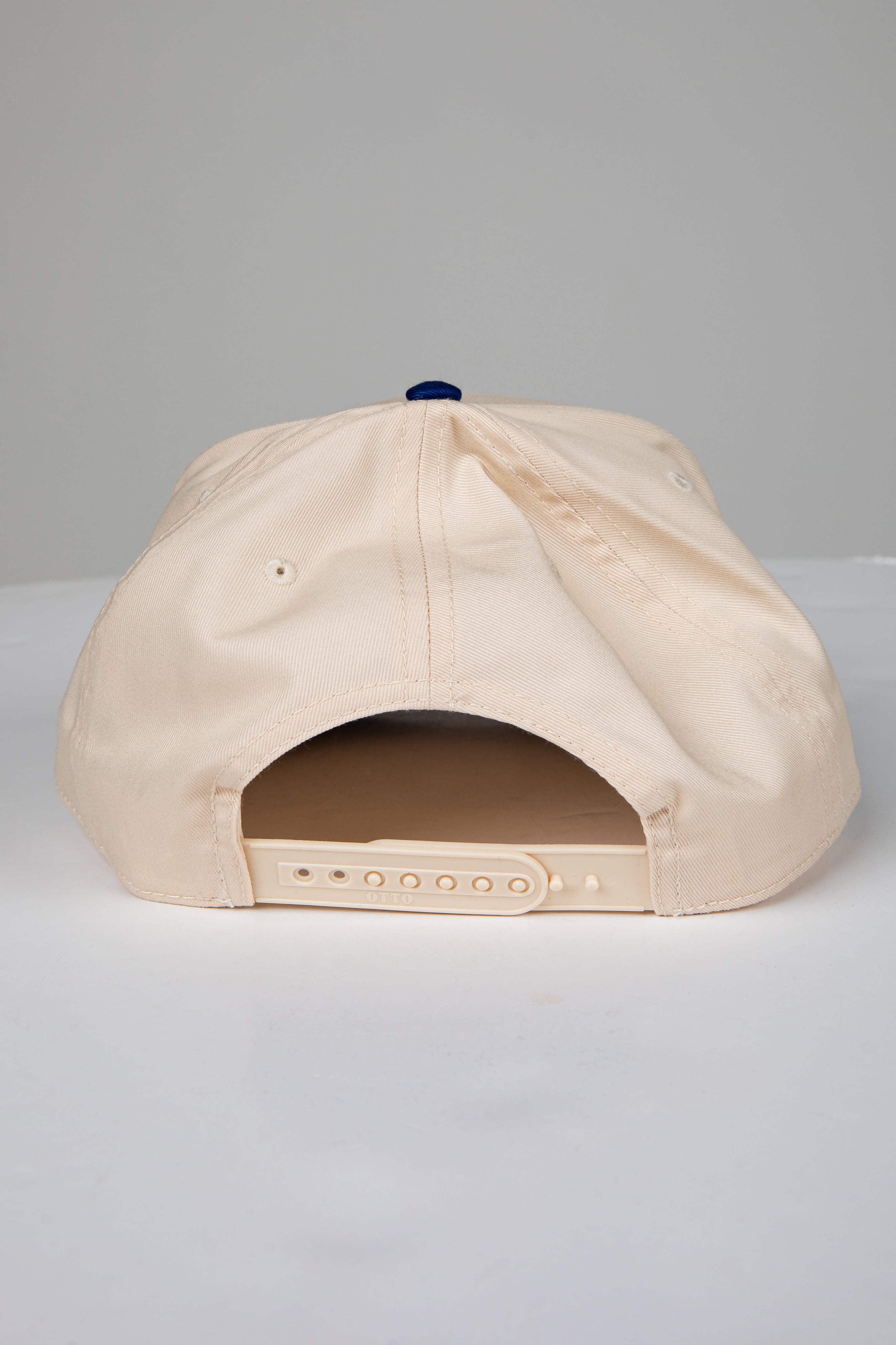 Beige baseball cap on a light gray background