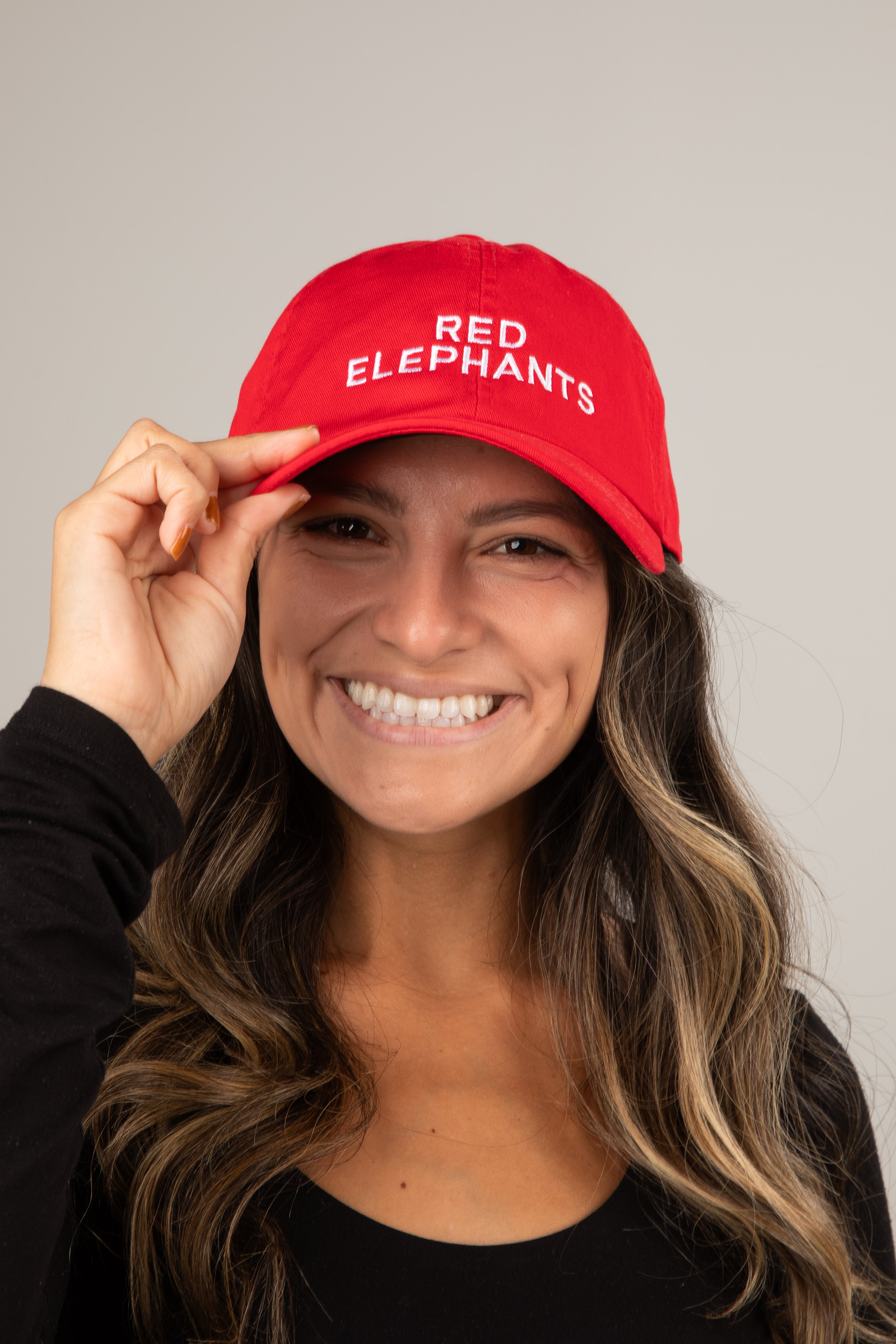 Woman wearing a red cap with &