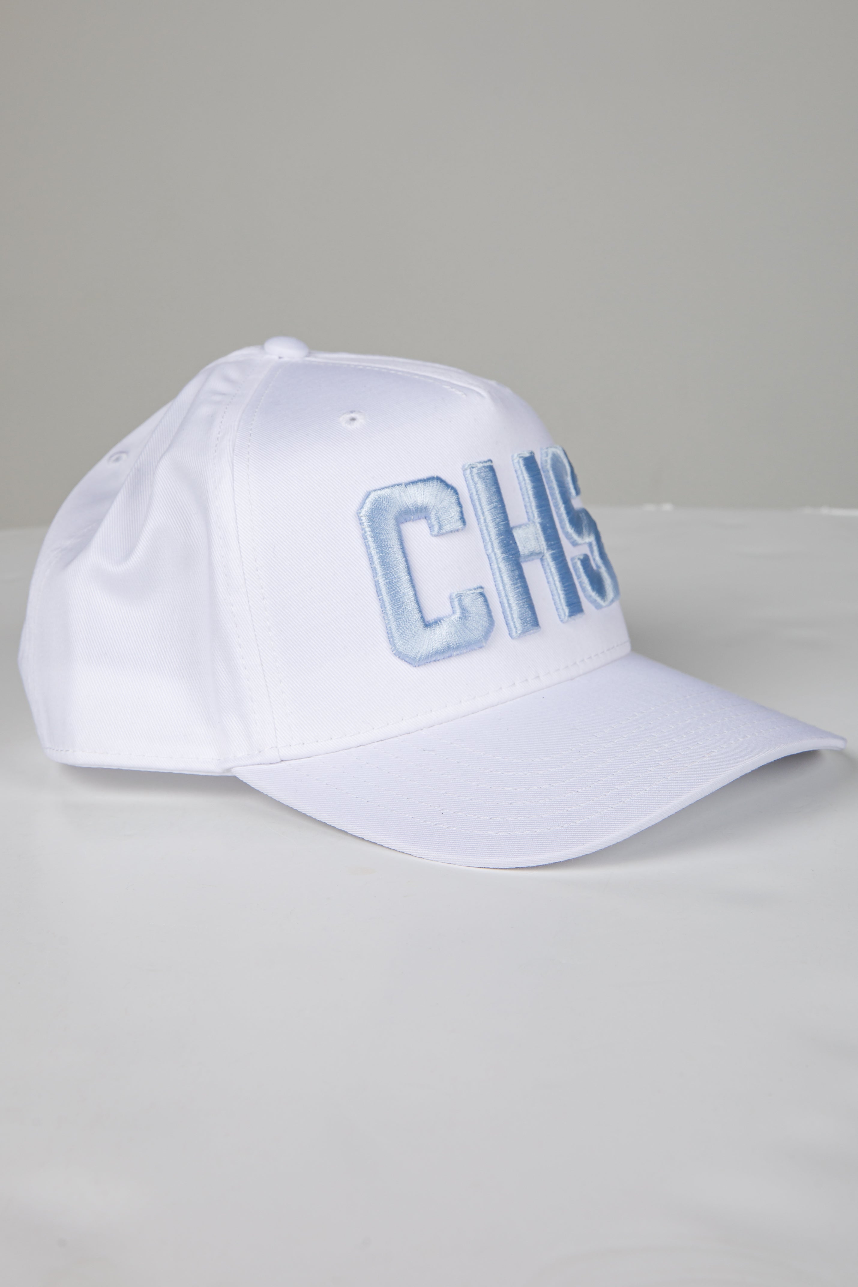 White cap with blue text on a gray background