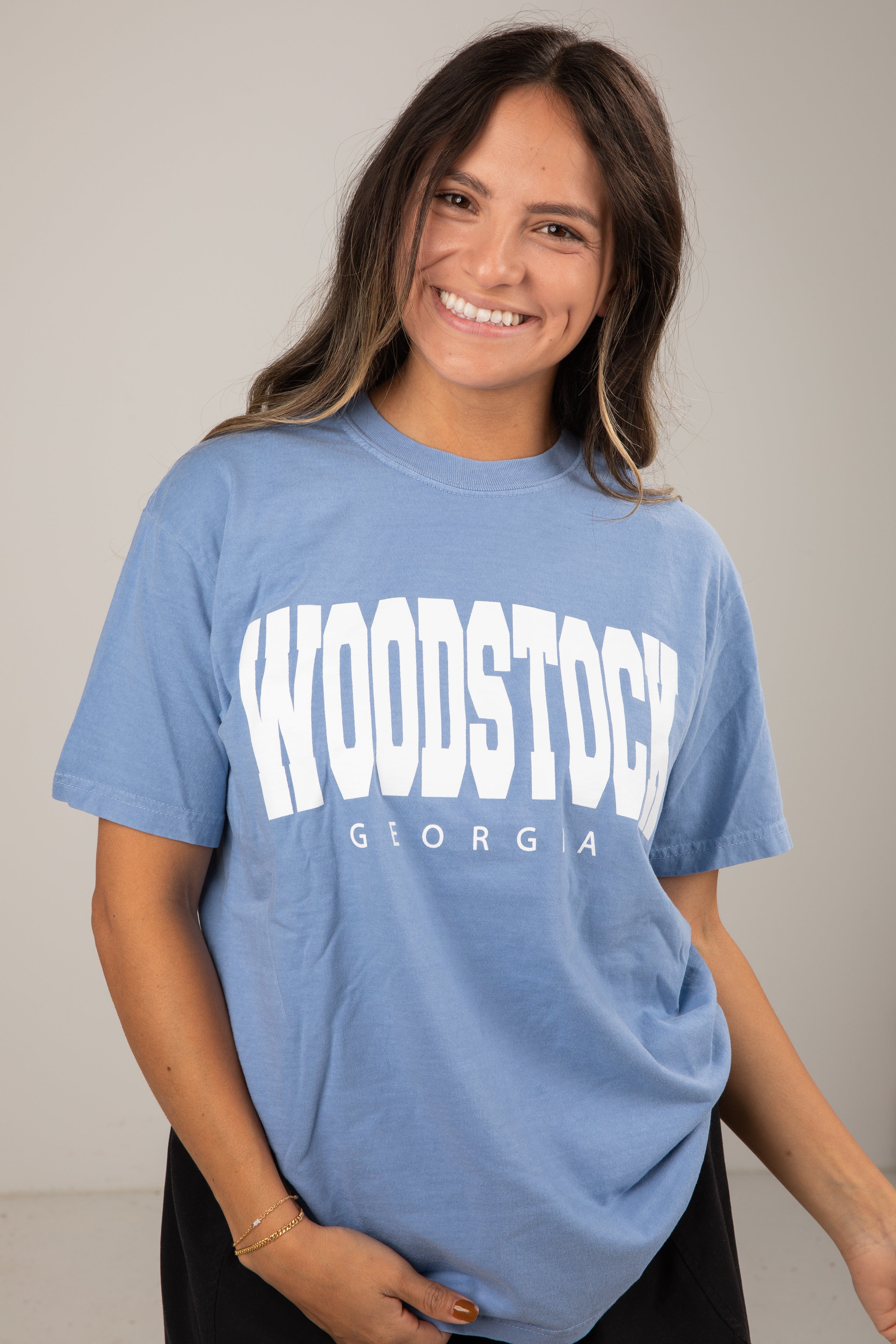 Woman wearing a blue t-shirt with &