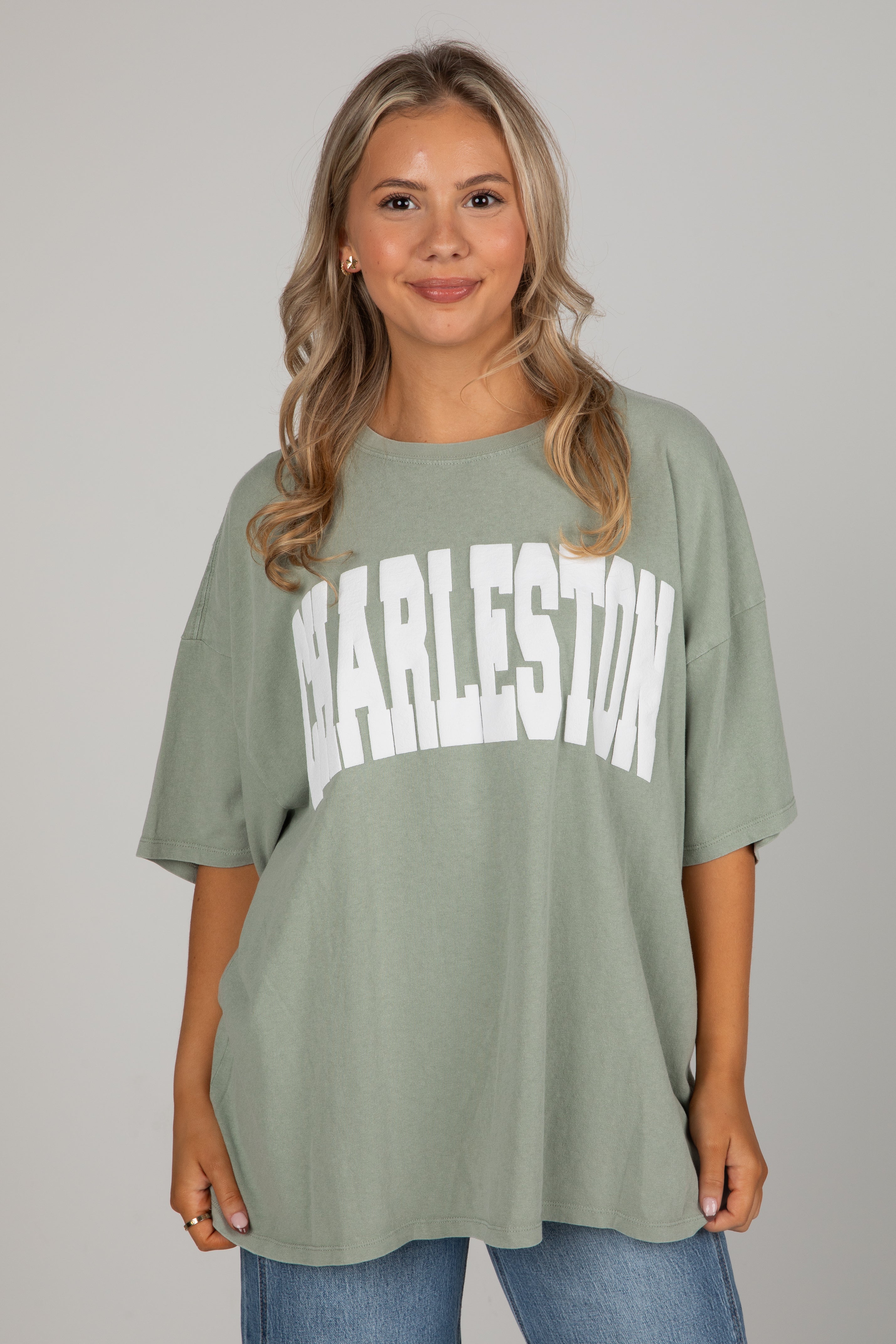 Woman wearing a green t-shirt with &