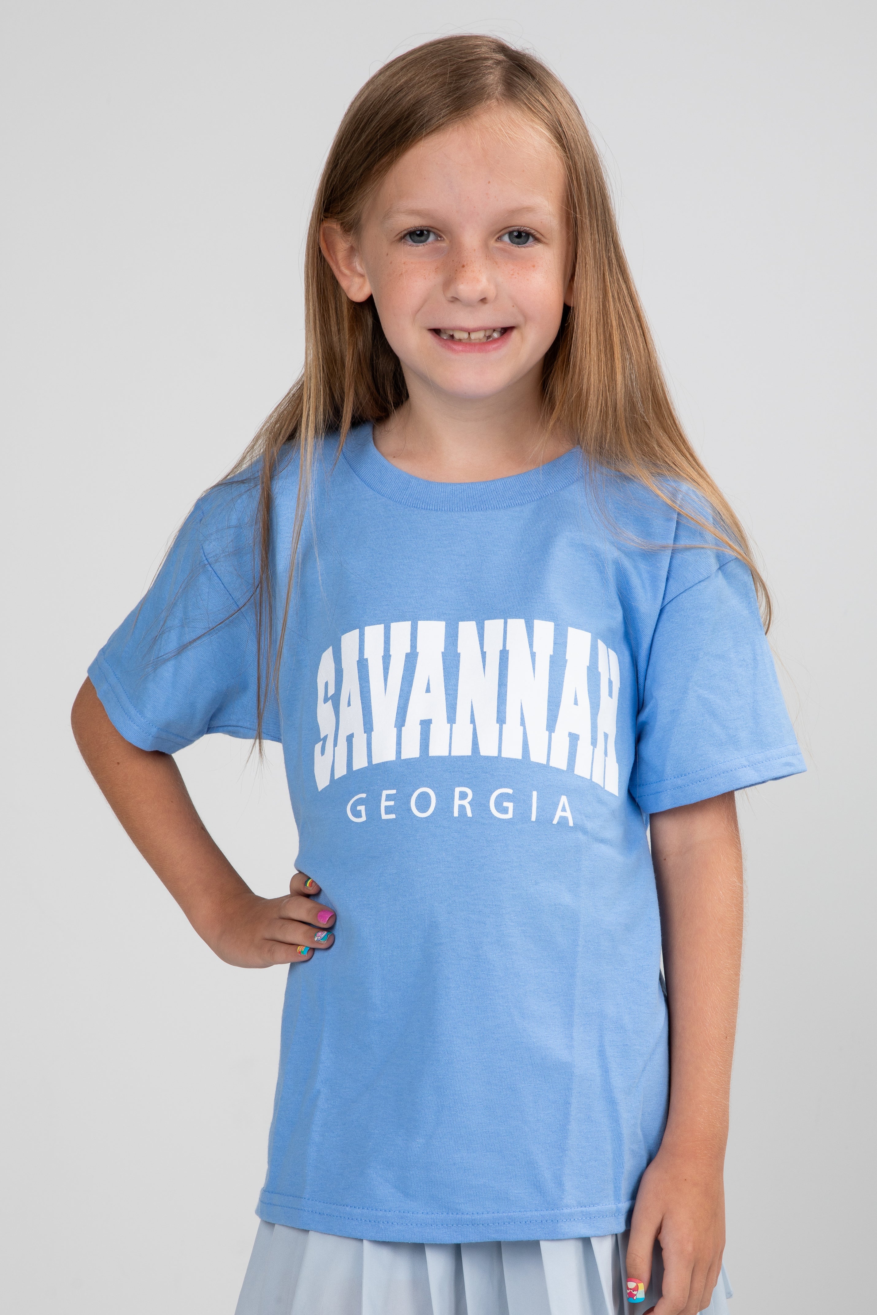 Young girl wearing a blue t-shirt with &