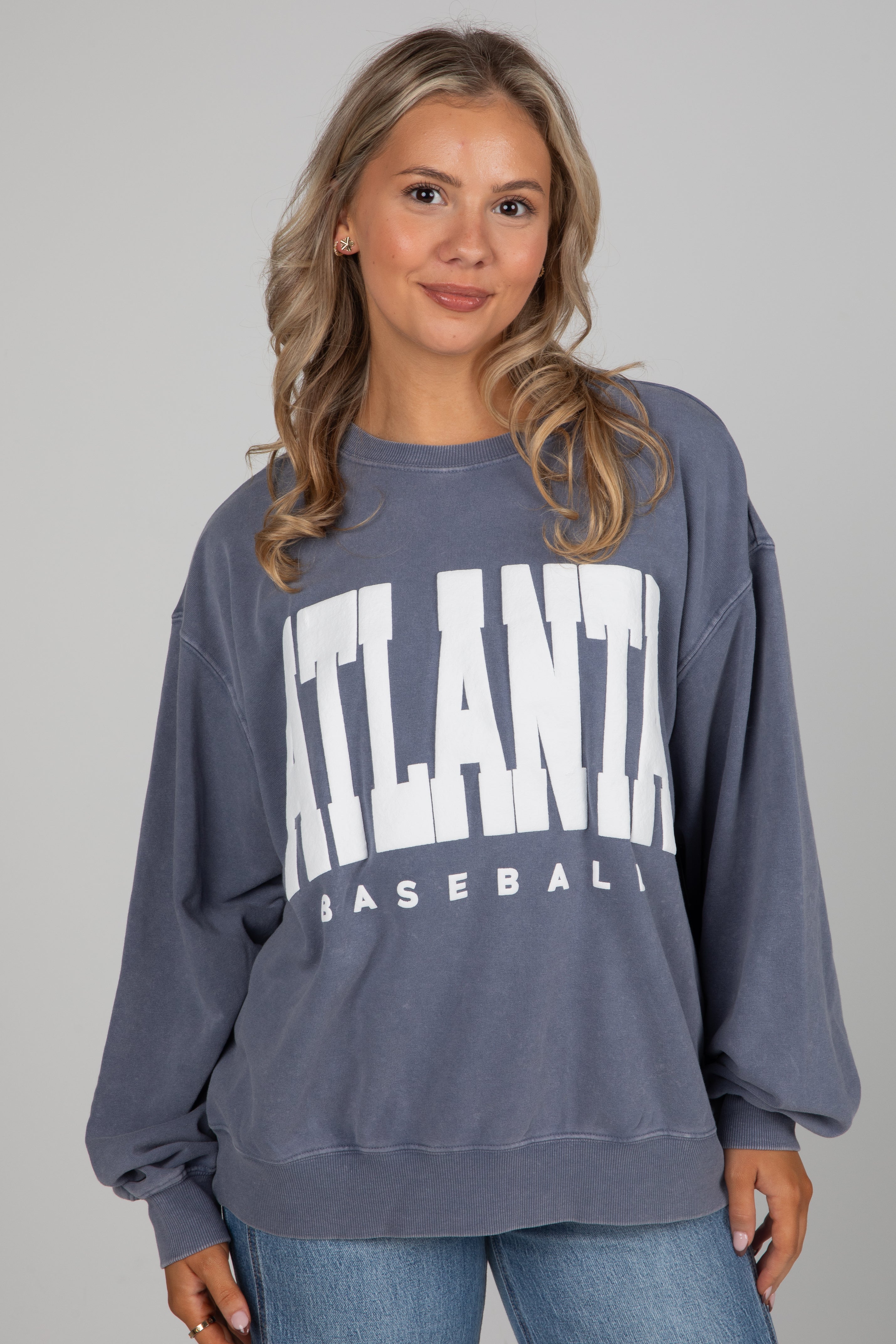 Woman wearing a blue sweatshirt with &