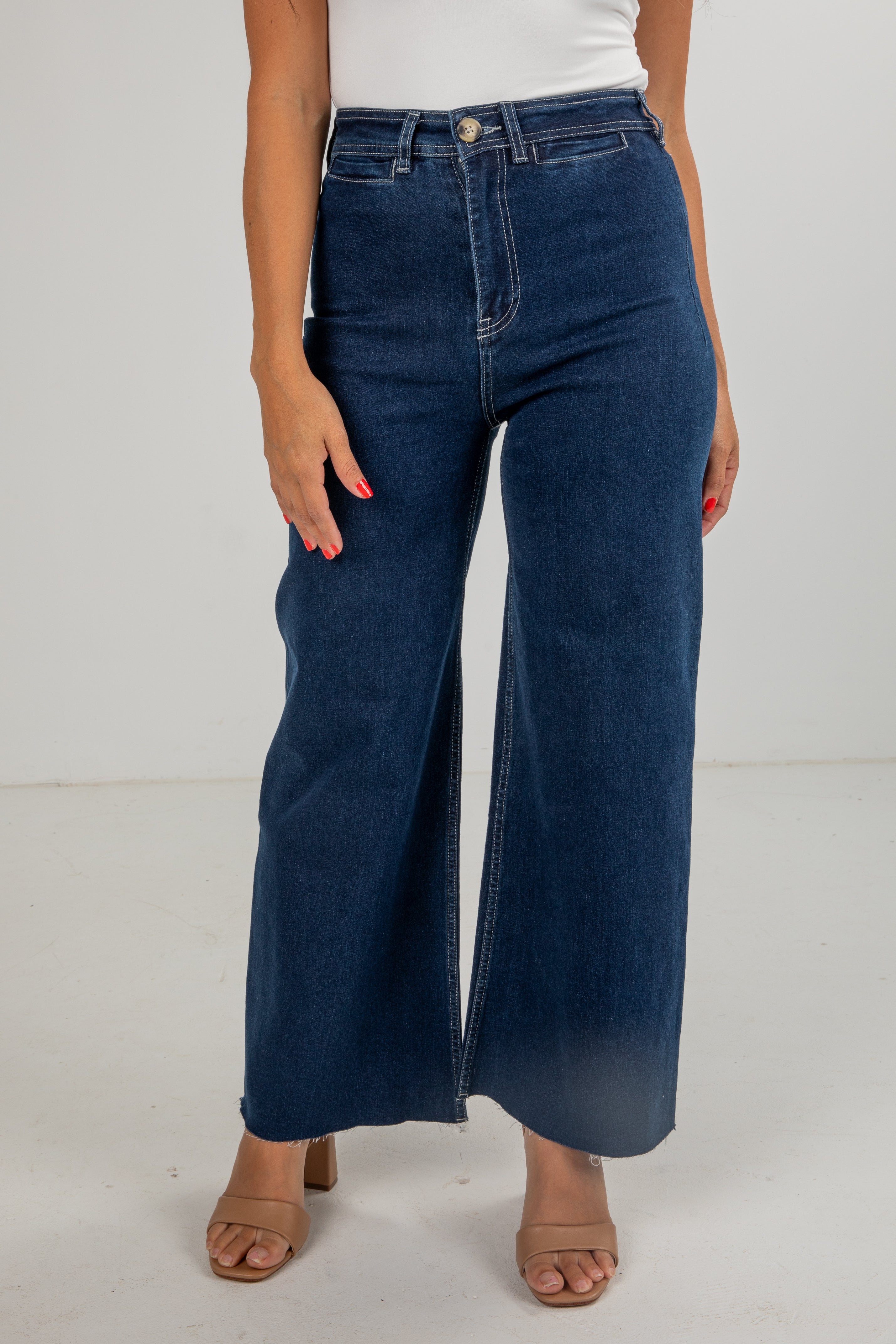 Person wearing blue wide-leg jeans on a white background