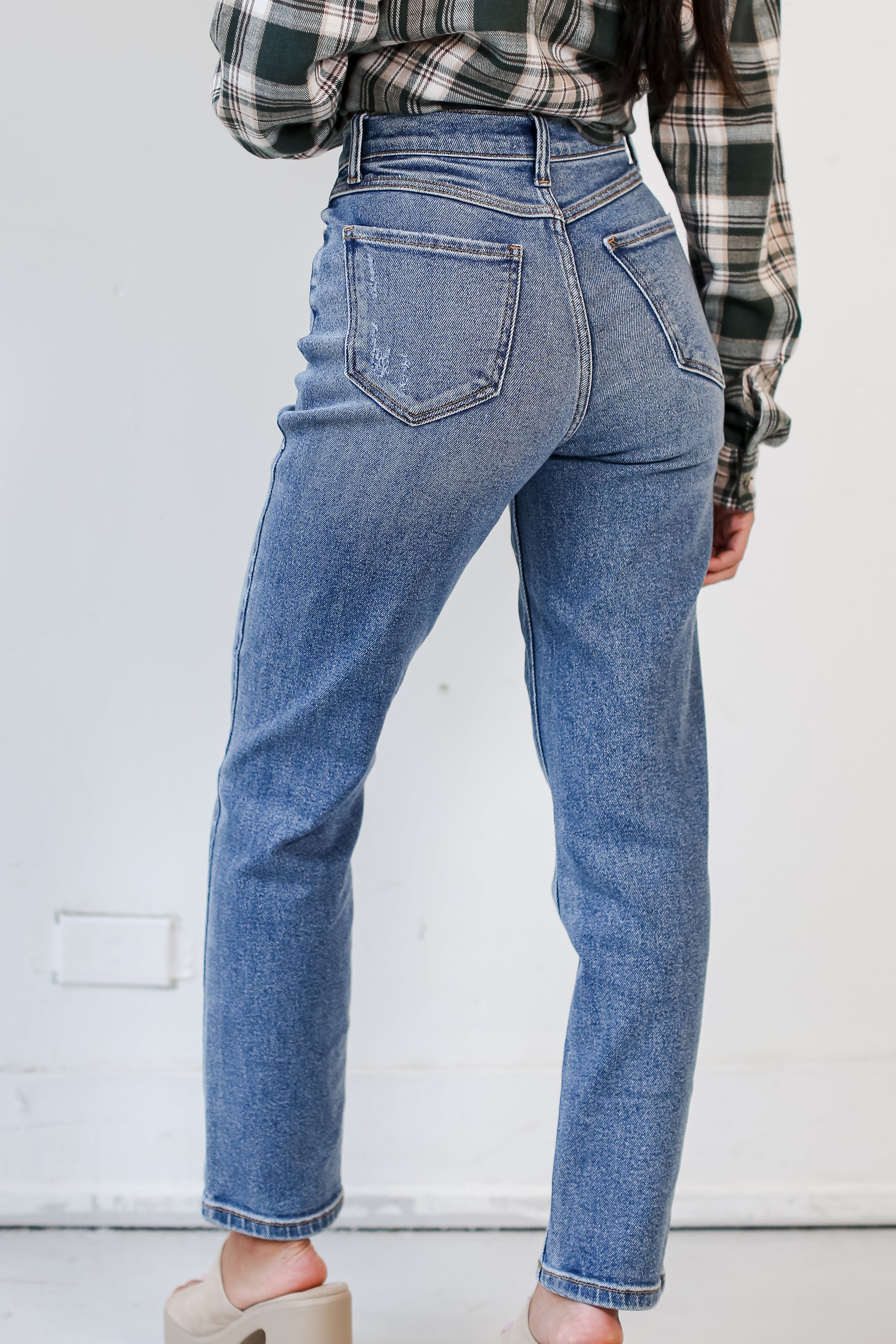 medium wash Mom Jeans on dress up model back view