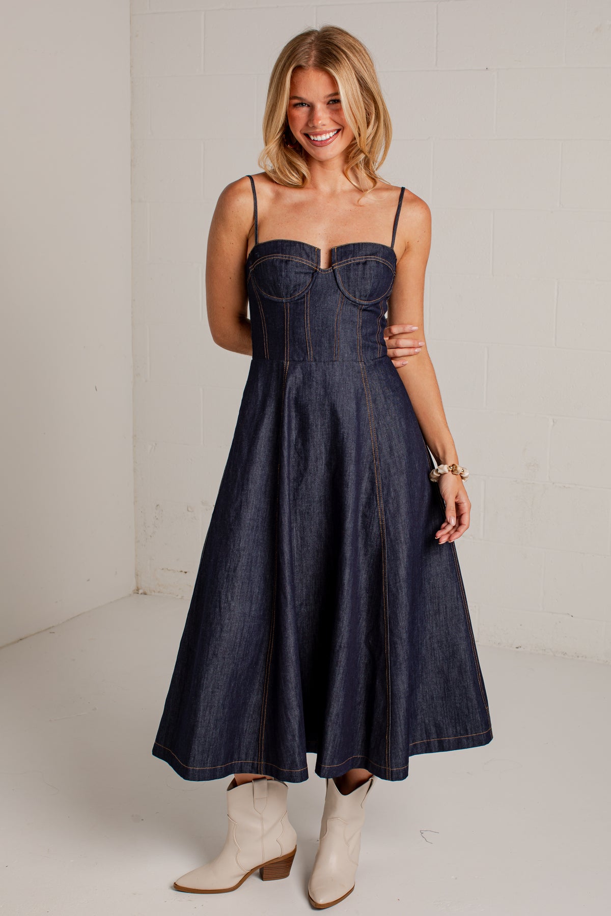 dark-wash dress features a strapless bustier-inspired bodice with defined seaming and a flattering fitted silhouette