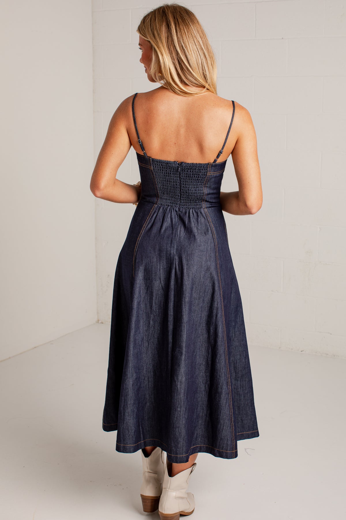 dark-wash dress features a strapless bustier-inspired bodice with defined seaming and a flattering fitted silhouette