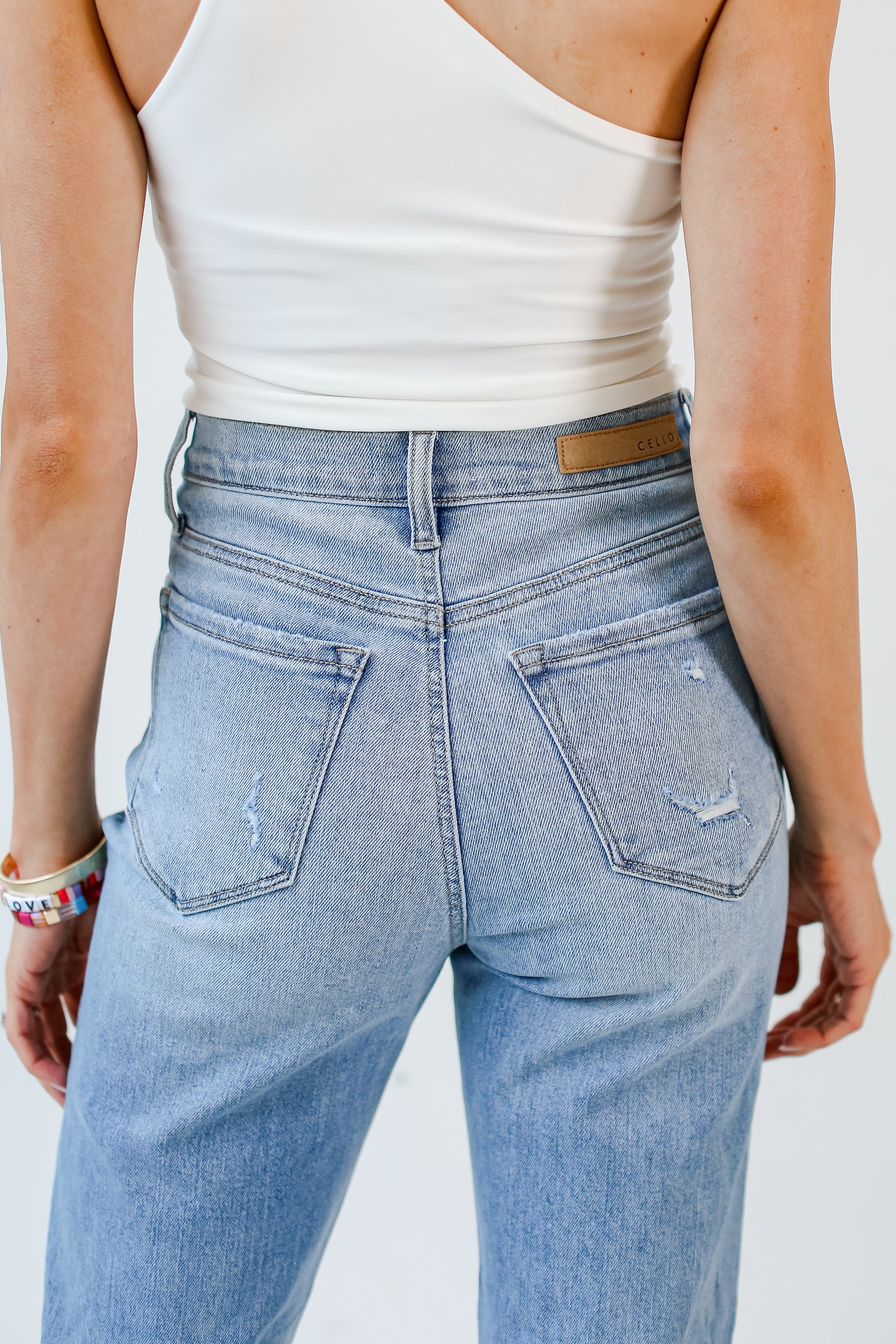 medium wash Distressed Mom Jeans back view close up
