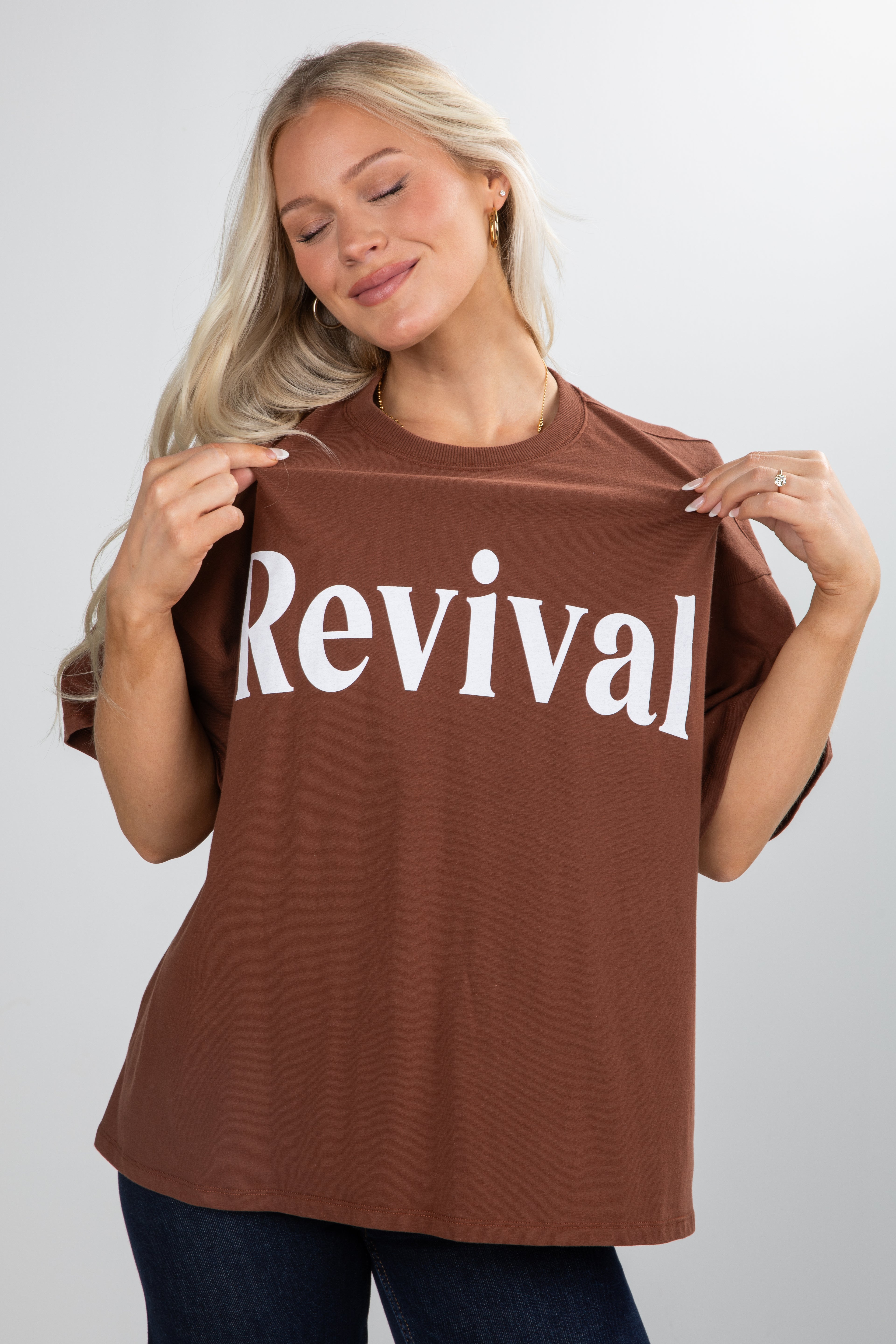 Woman wearing a brown t-shirt with &