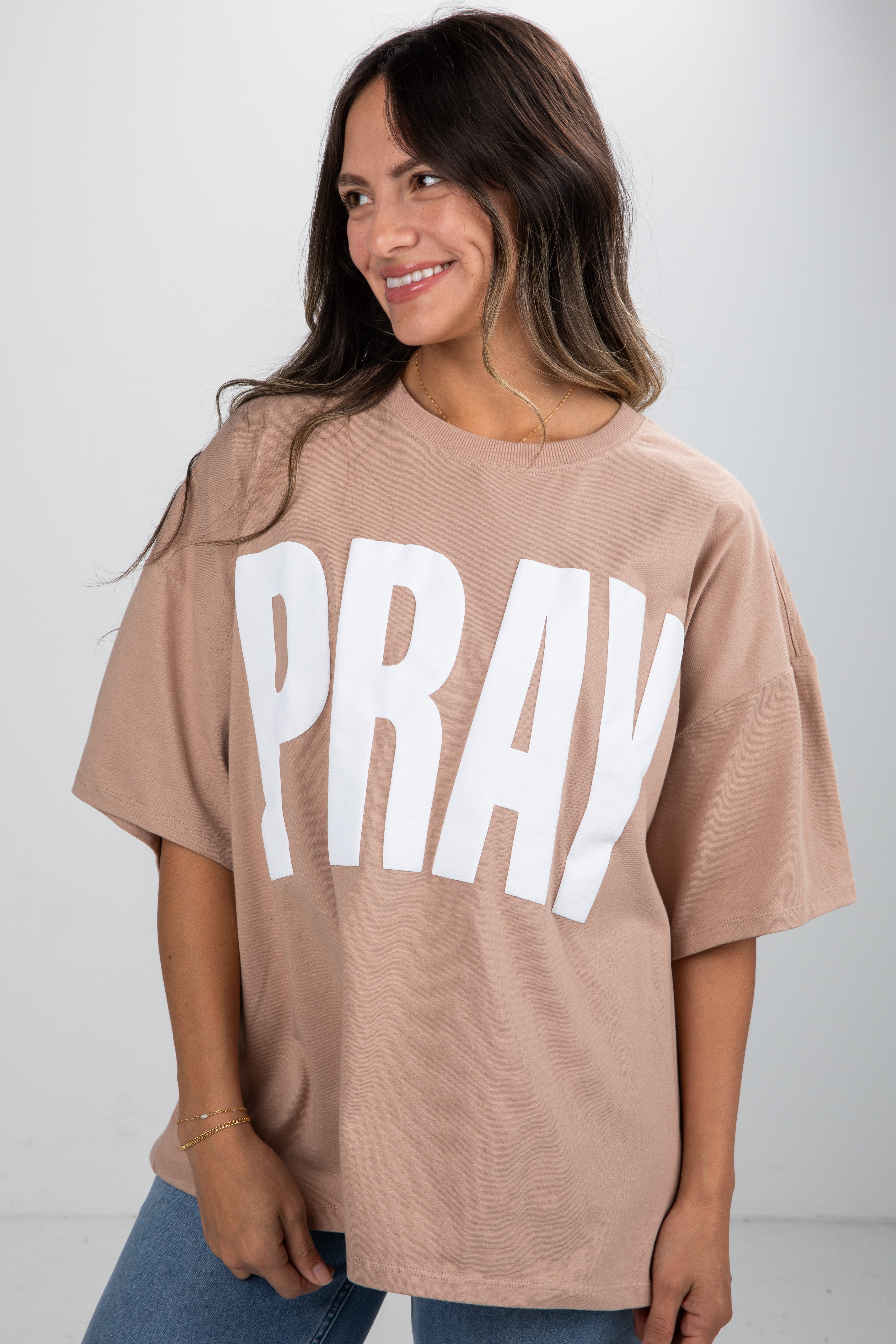 Woman wearing a beige t-shirt with &
