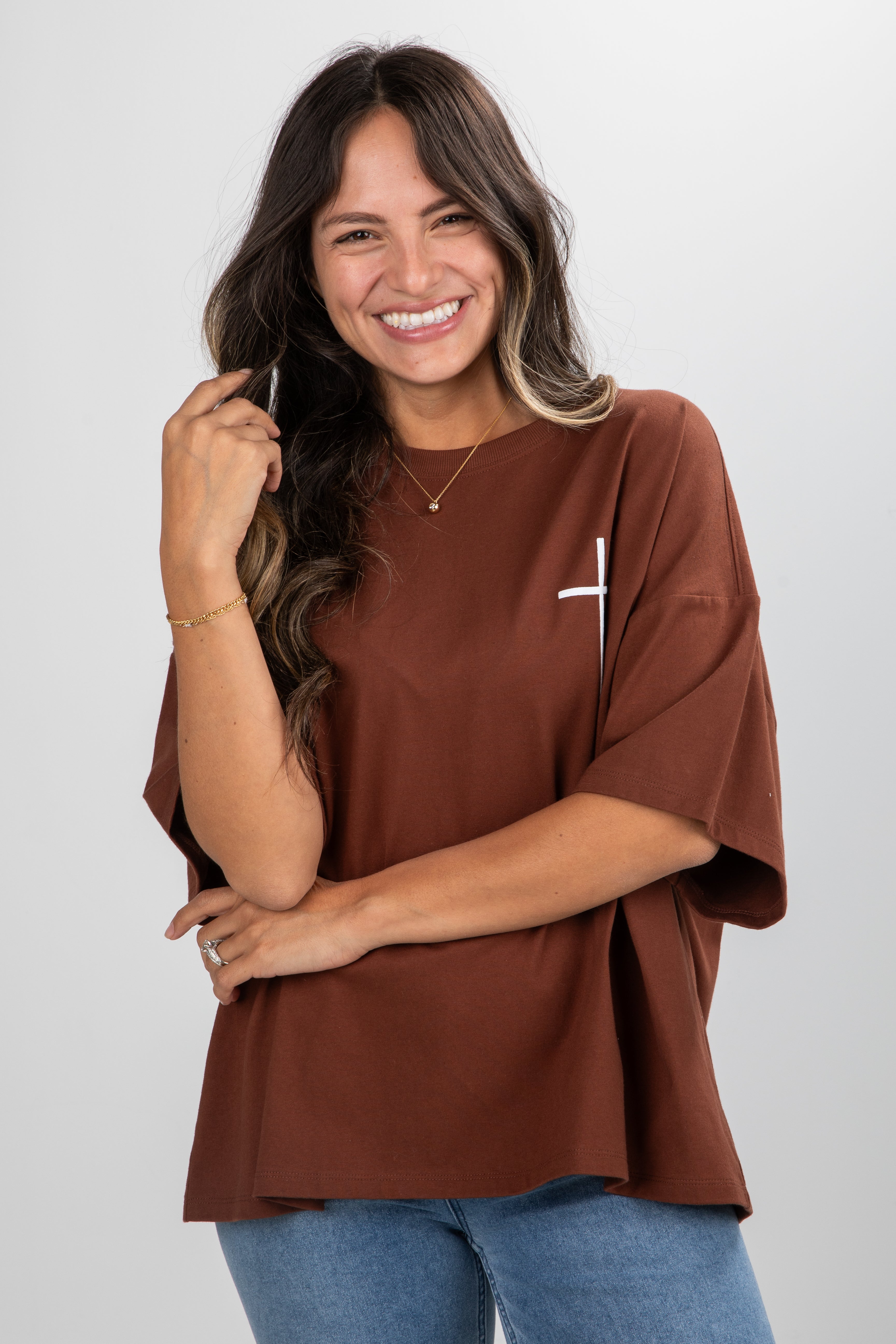 Woman wearing a brown oversized shirt with a white background