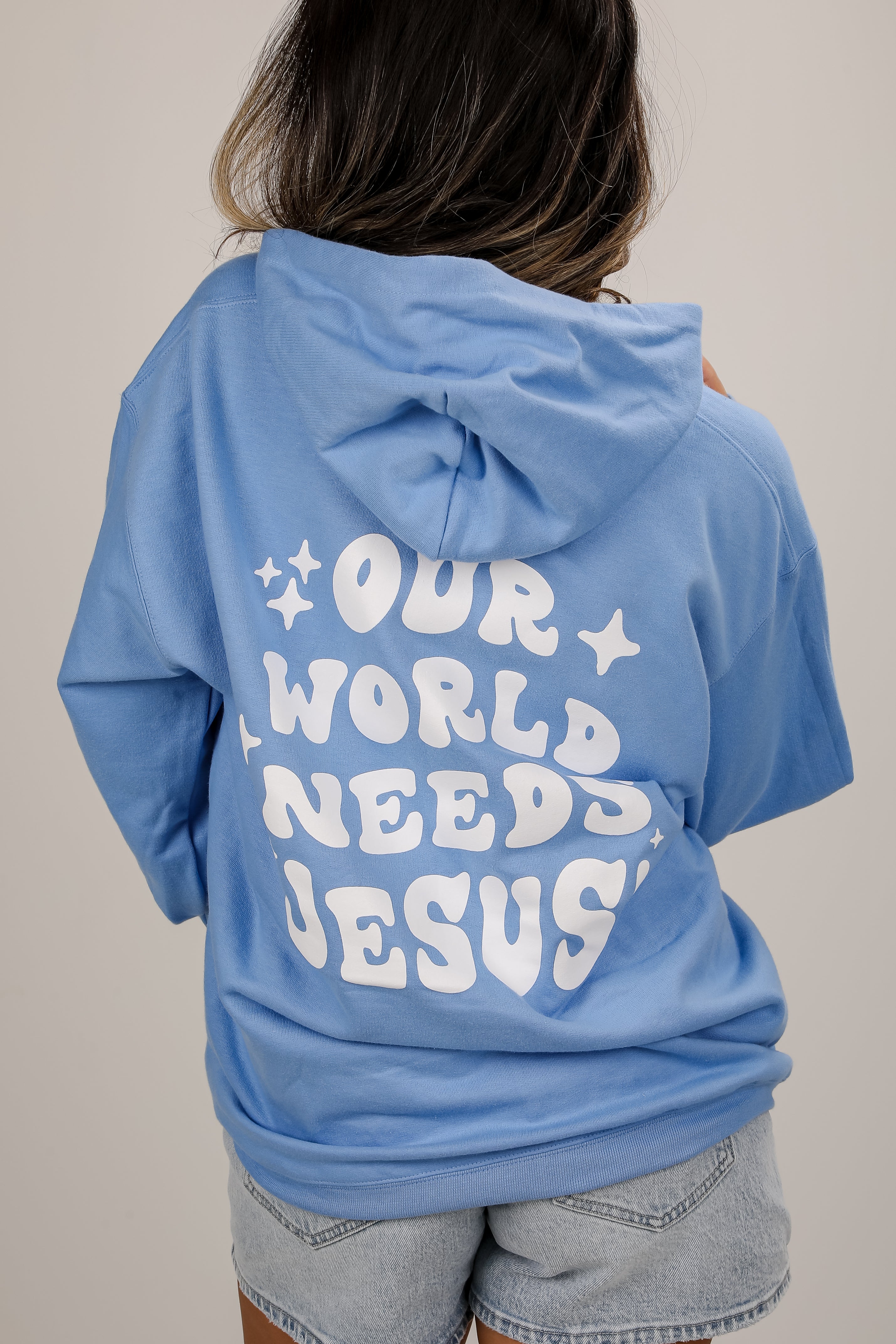 Light Blue Our World Needs Jesus Hoodie | DU Exclusives | DressUp Light Blue / XX-Large Light Blue Our World Needs Jesus Hoodie | DU Exclusives | DressUp Light Blue / XX-Large
