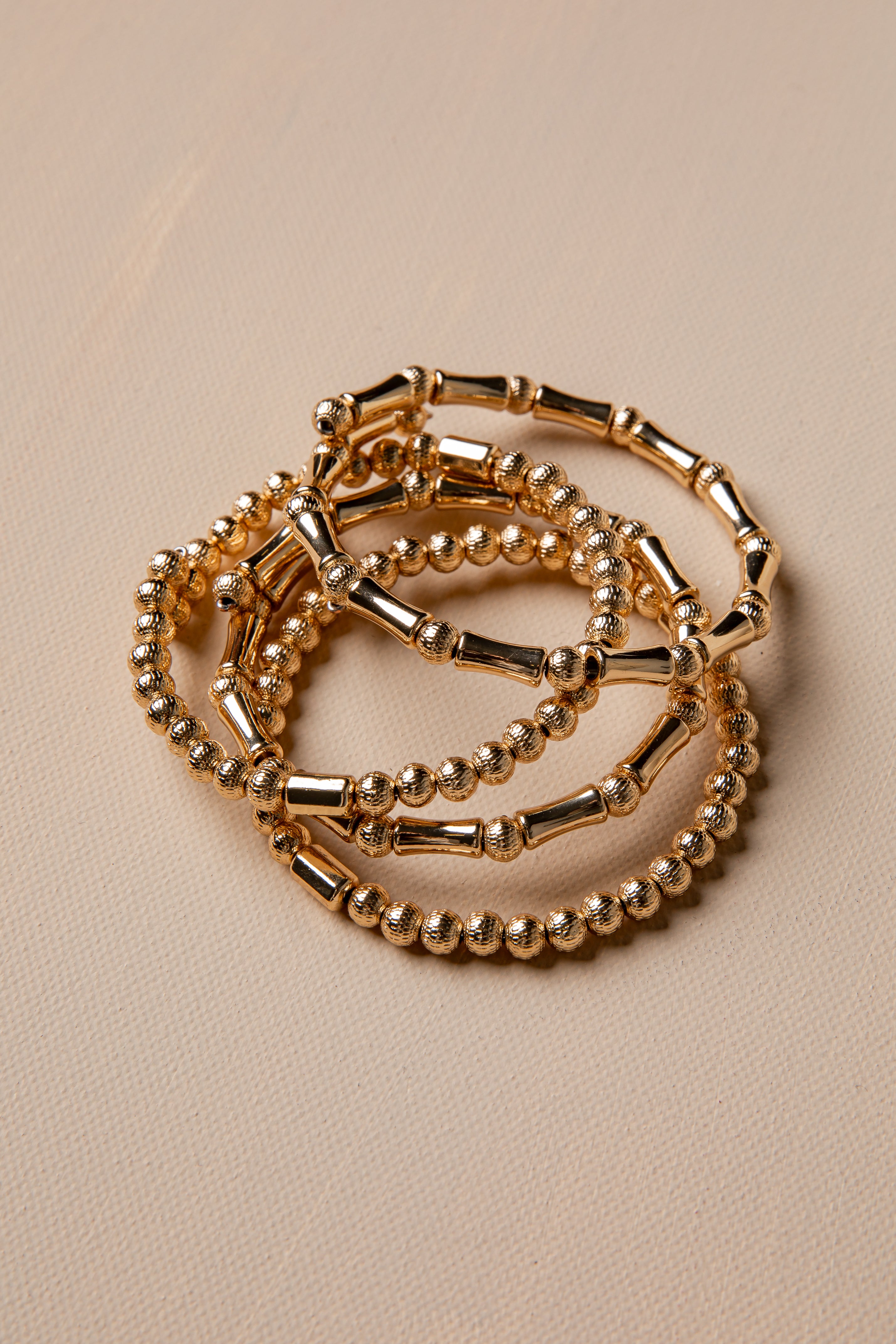 Gold bracelet on a beige background