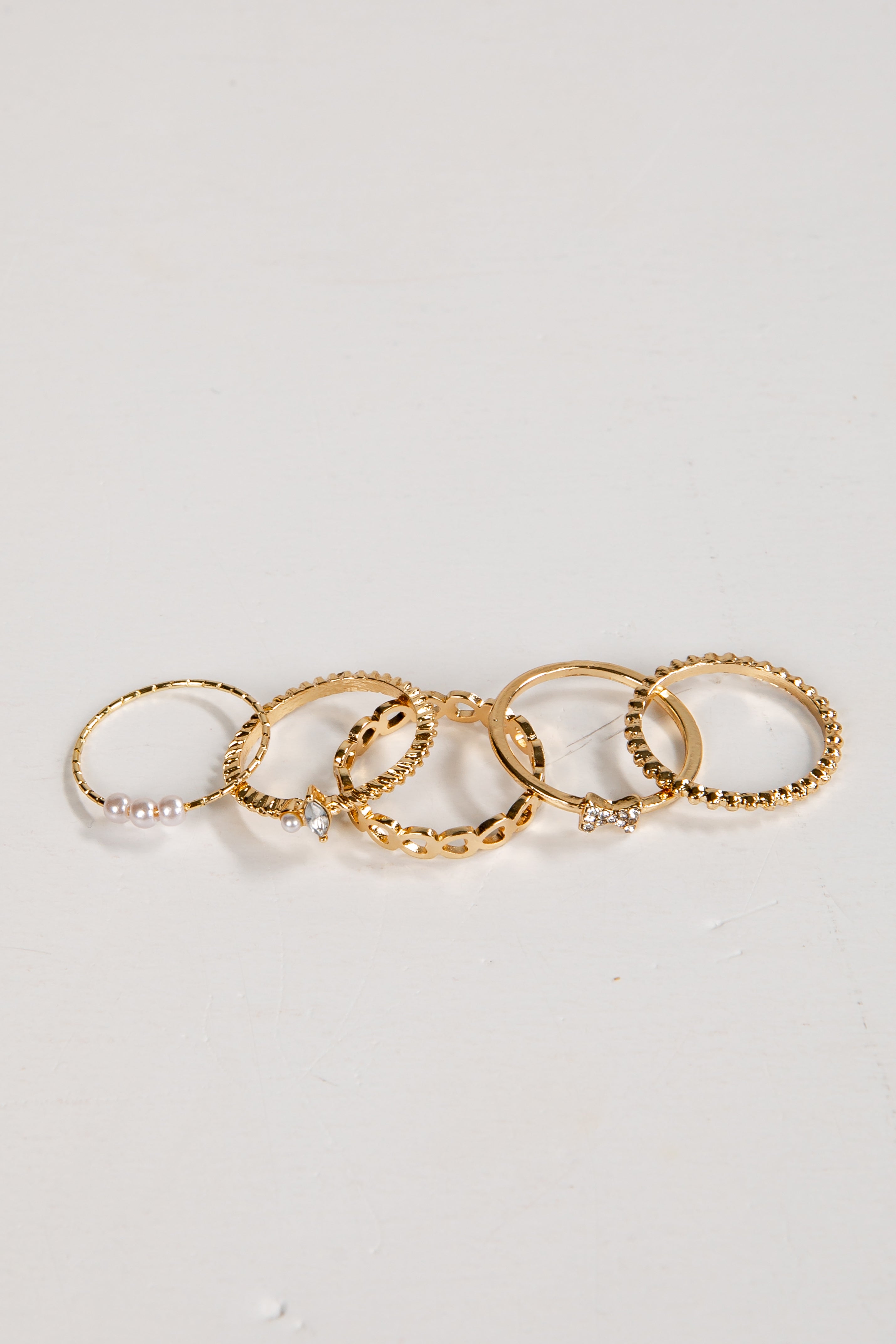 Set of gold rings on a light gray background